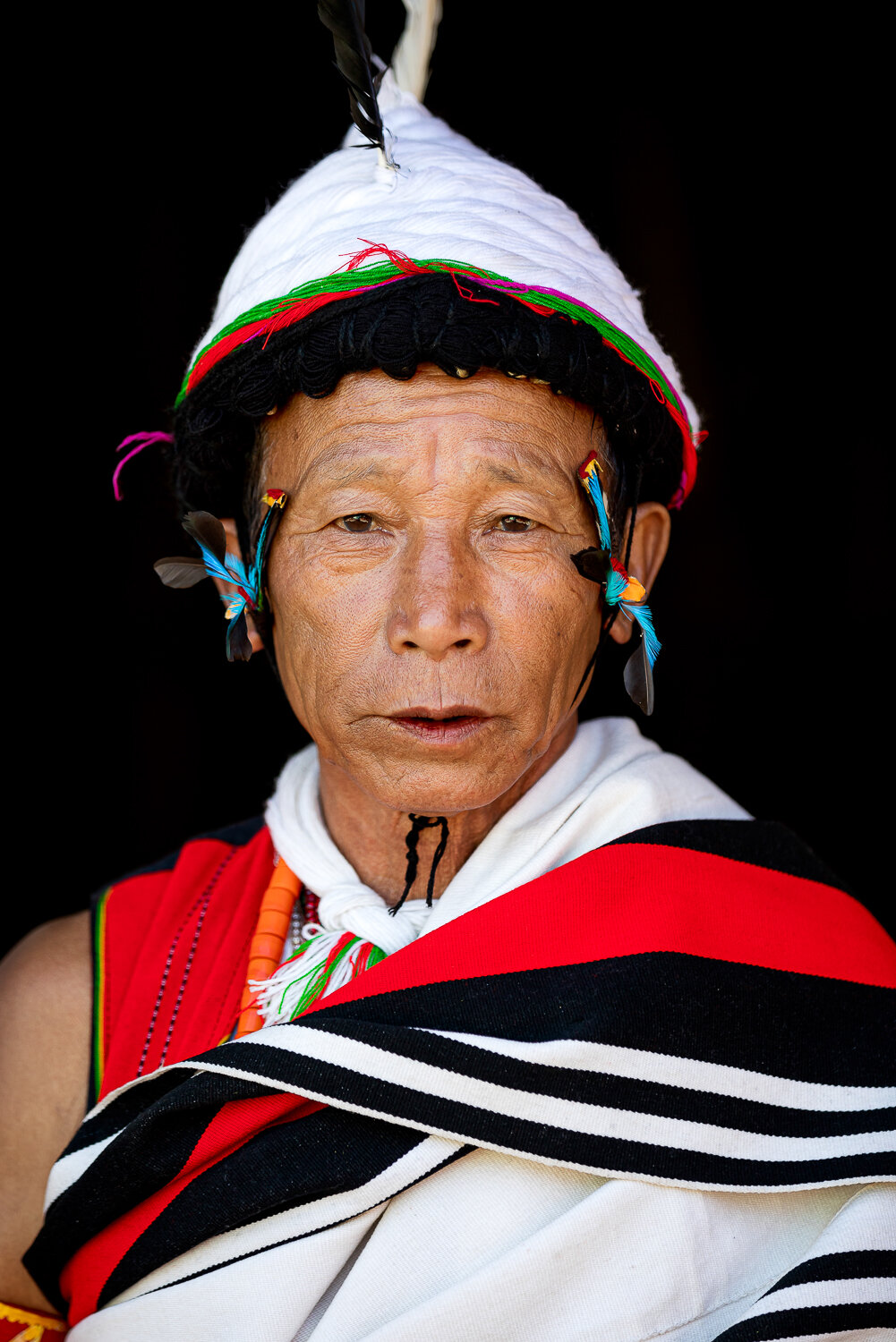 portrait of old man from north east showcasing tribal attire during hornbill festival in nagaland