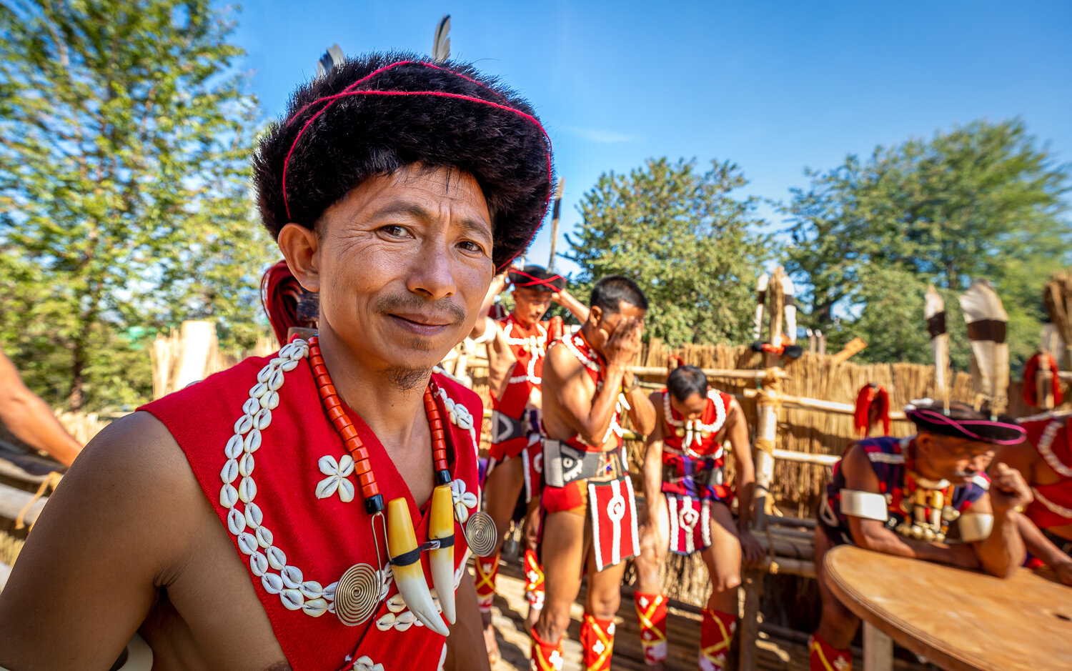 naga tribe resting outside their Morung during hornbill festival in nagaland