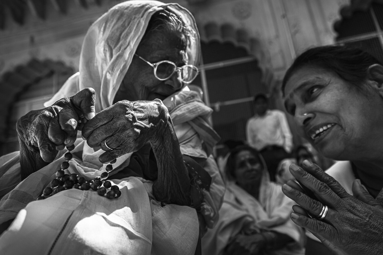 widow of vrindavan talking with visitor and locals by prathamesh dixit.jpg