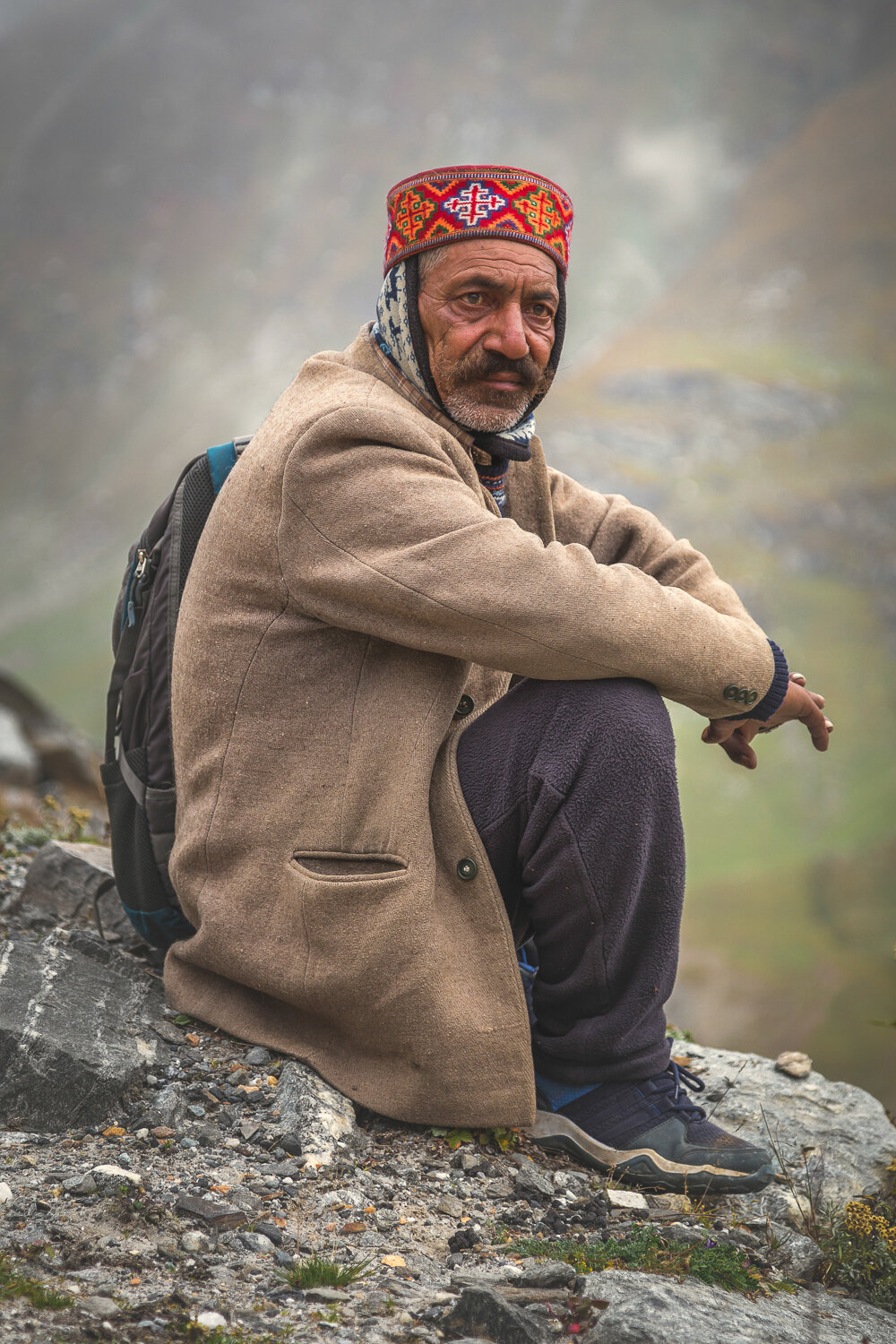 man sitting on mountain in himachal pradesh by prathamesh dixit.jpg
