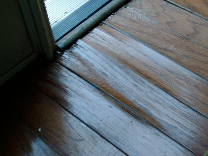 Moisture Damage To Flooring Covered By Rug At Entryway