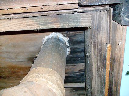 Furnace Vent Pipe Lacks Proper Clearance From Combustibles And Wood Has Begun To Char