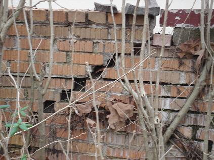 Failing Retaining Wall Causing Driveway Above It To Begin To Collapse