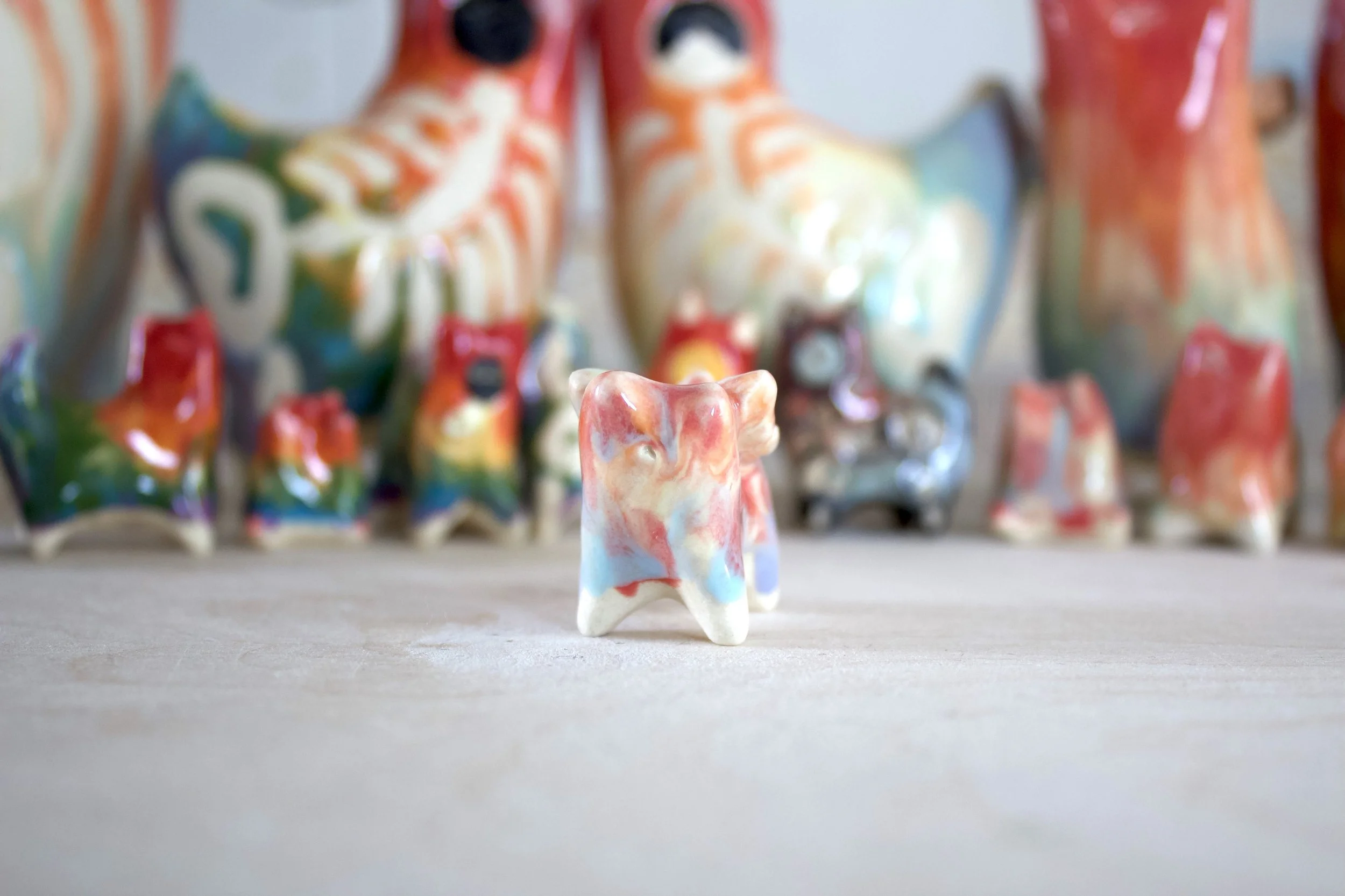 One-of-a-kind handmade ceramic Pastel Rainbow Butterfly Cat viewed from the front.jpeg