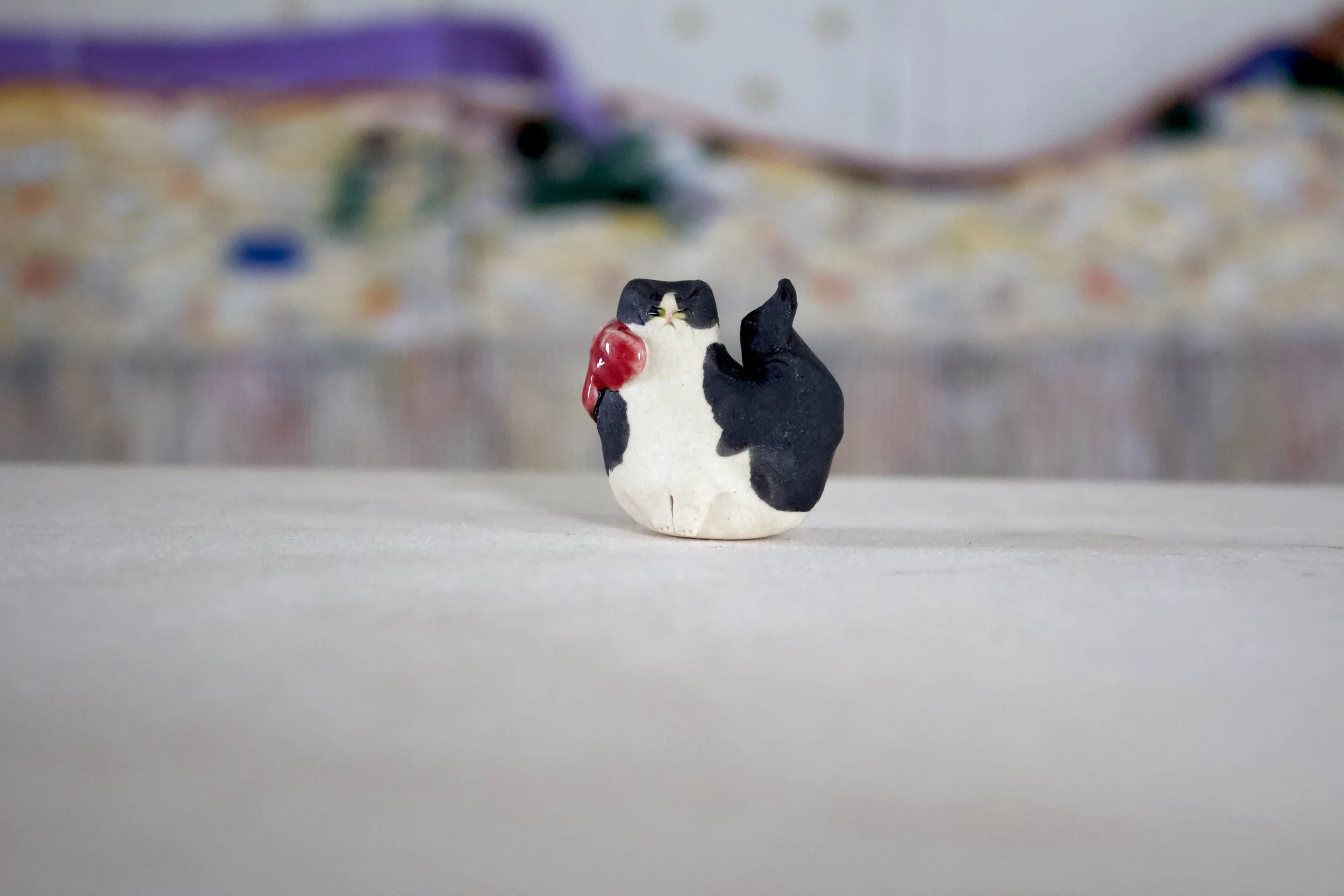 Tuxedo Cat with Red Bow and Yellow Eyes Sitting - Cat Sculpture with Food Bowl