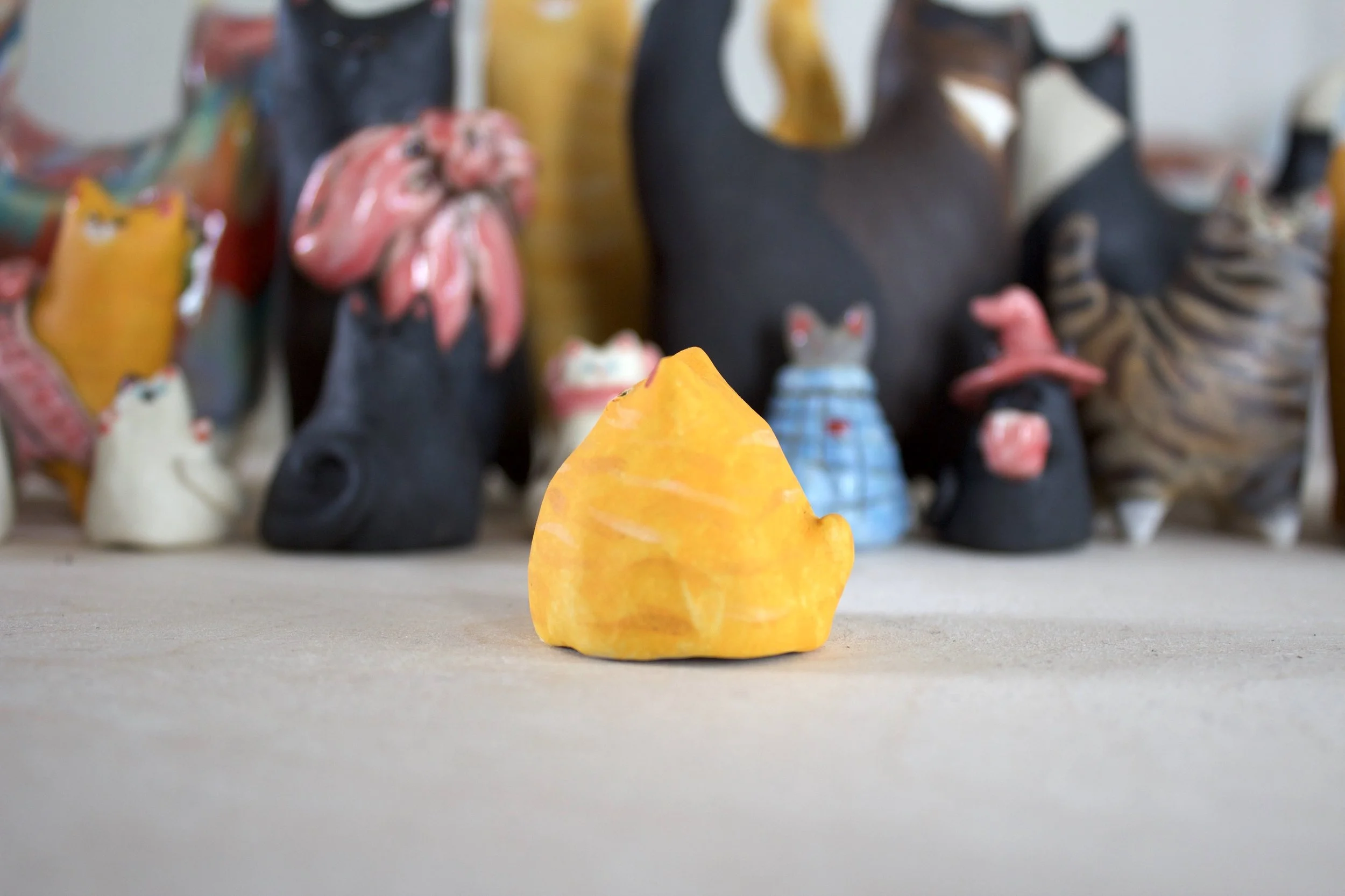 Side view of orange tabby ceramic cat chime handmade sculpture.jpeg
