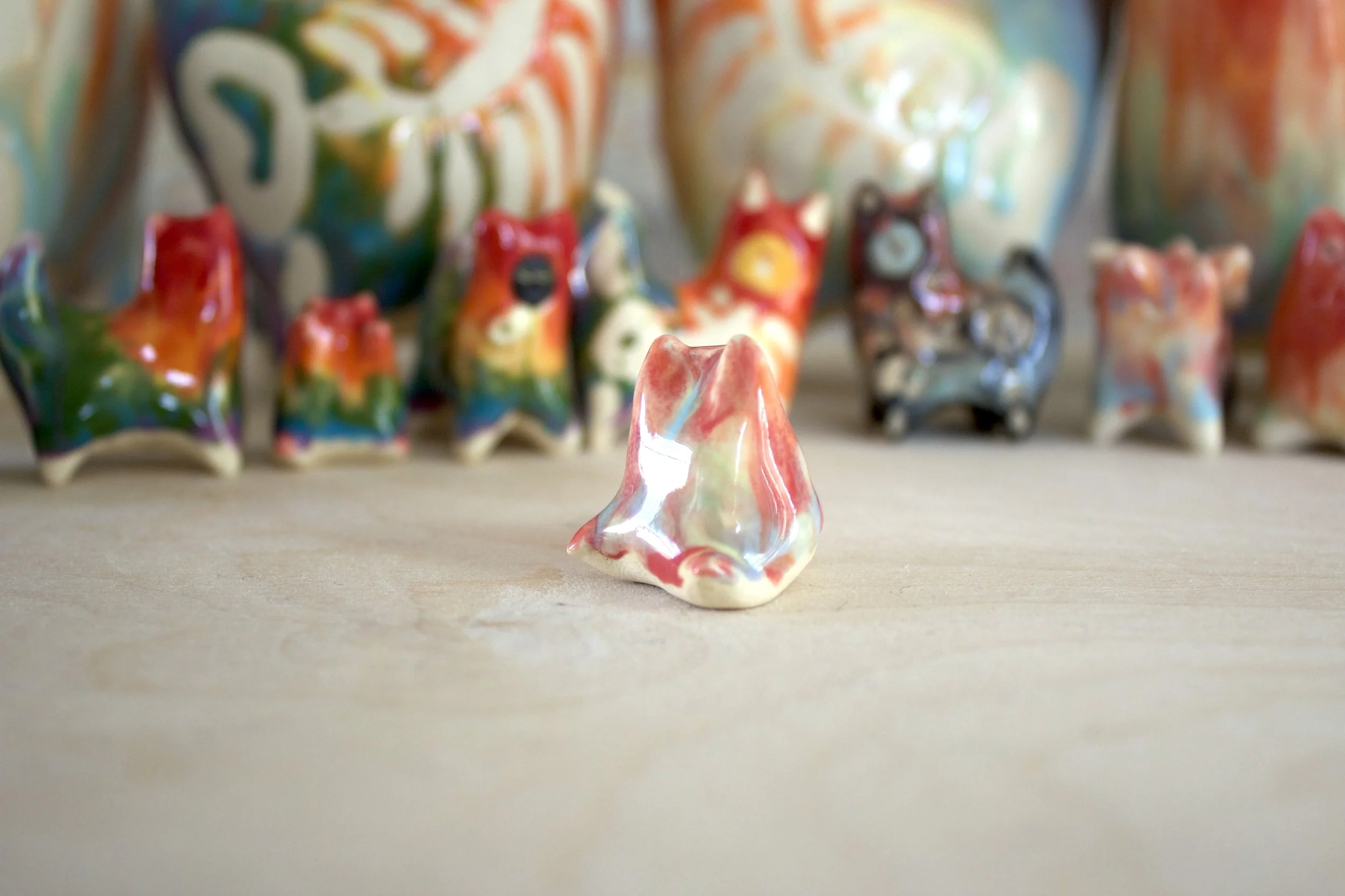 Three-quarter view of Pastel Rainbow Cat No. 1, a handmade ceramic cat sculpture.jpeg