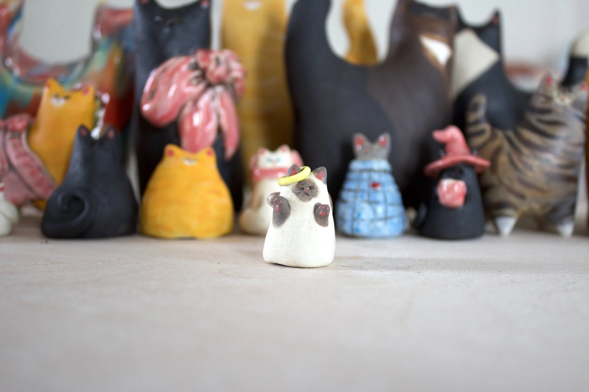 Lilac Point Siamese angel handmade ceramic cat chime with wings and crooked halo.jpeg