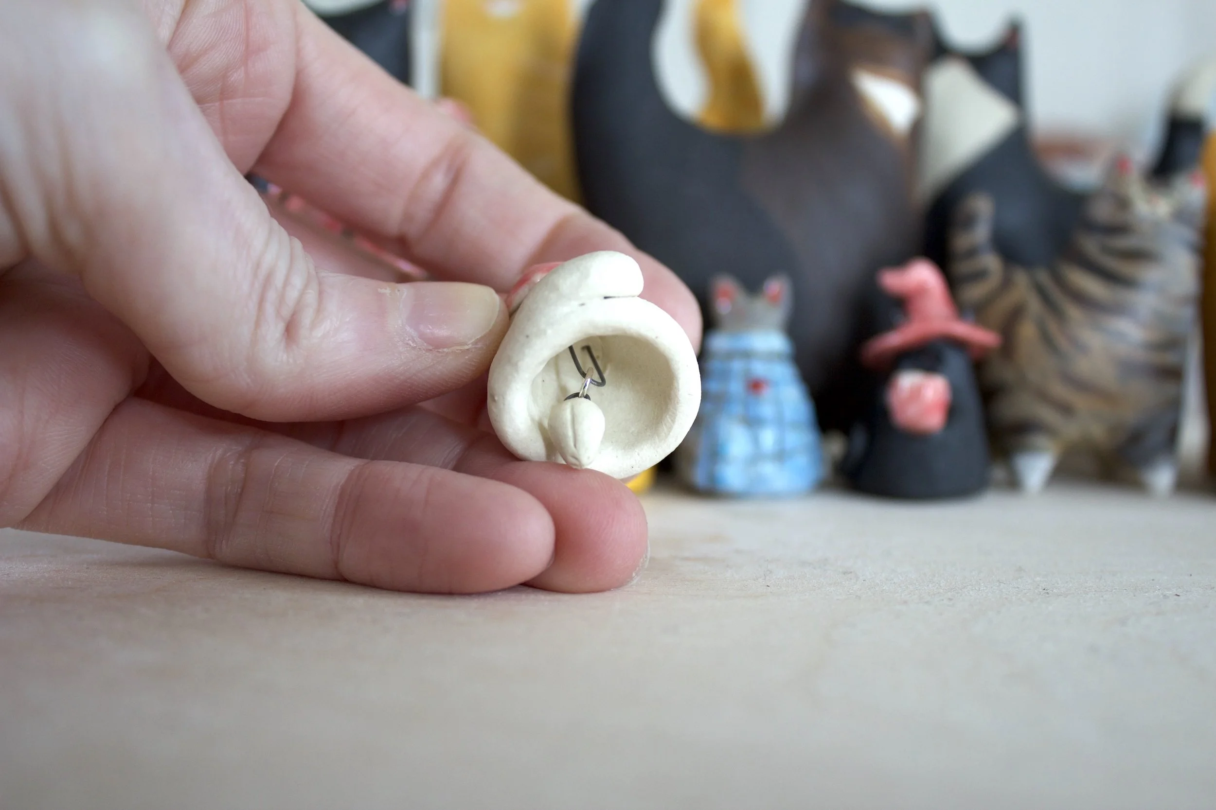 Snowball ceramic cat chime paw clapper detail.jpeg
