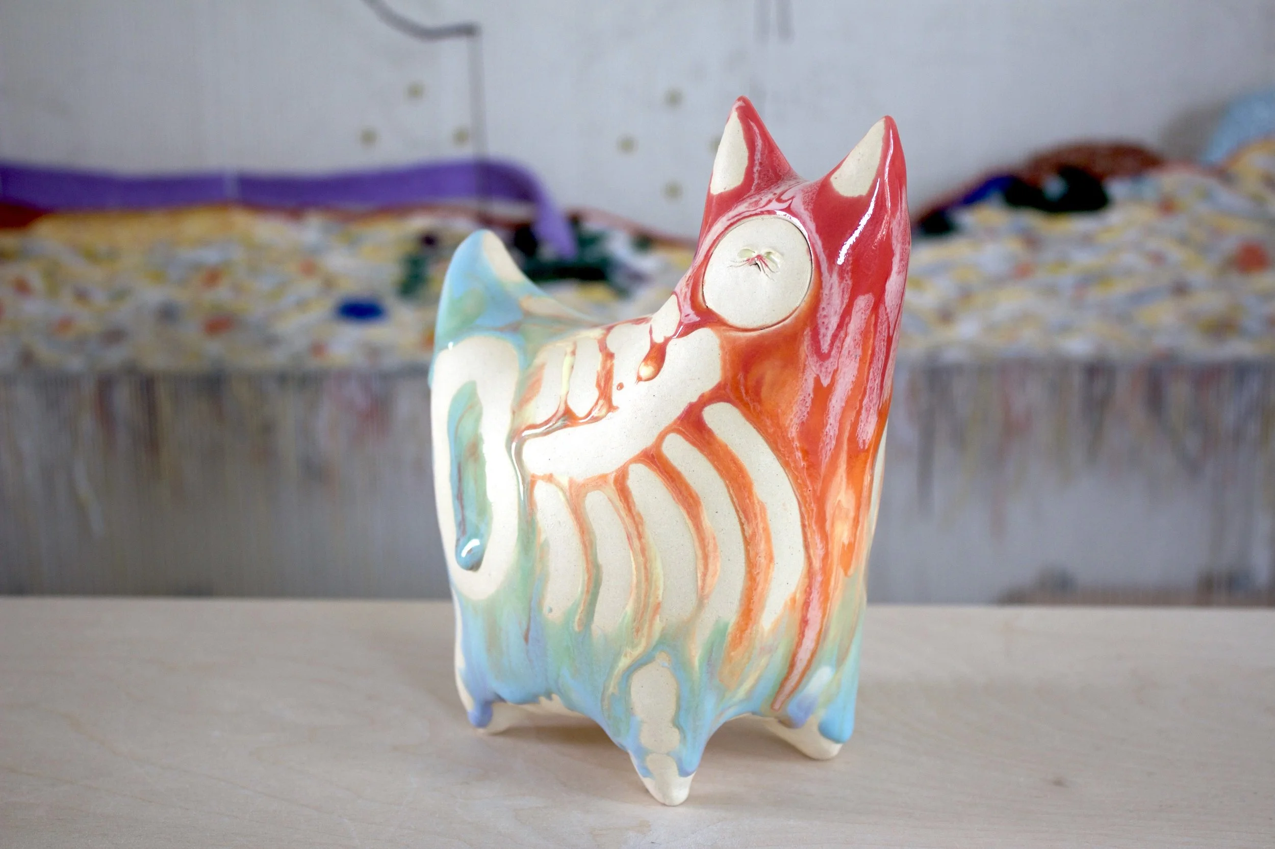 Three-quarter view of the XL Collector Pastel Goo Skeleton White Cat, a handmade ceramic cat sculpture.jpeg