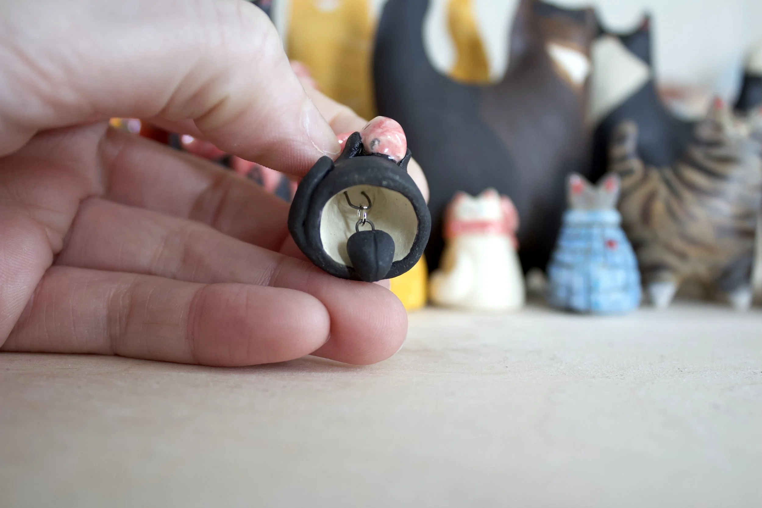 Void witch ceramic cat chime paw clapper detail.jpeg