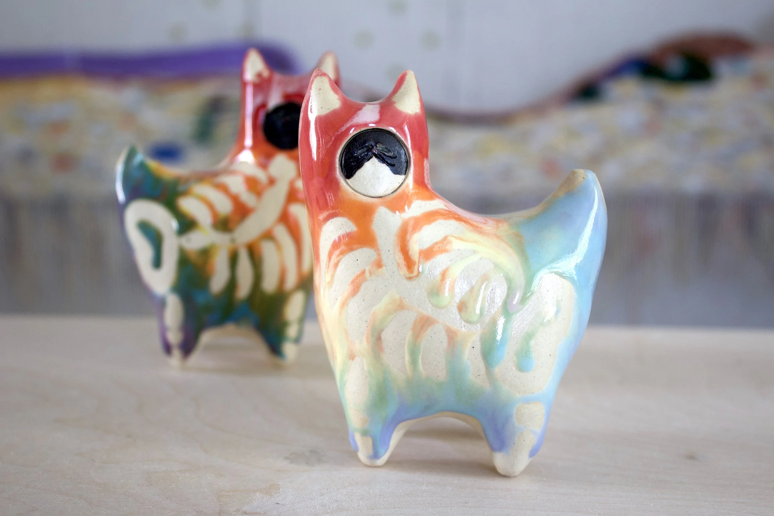 One-of-a-kind handmade large ceramic Pastel Rainbow Goo Skeleton Cat viewed from the front.jpeg