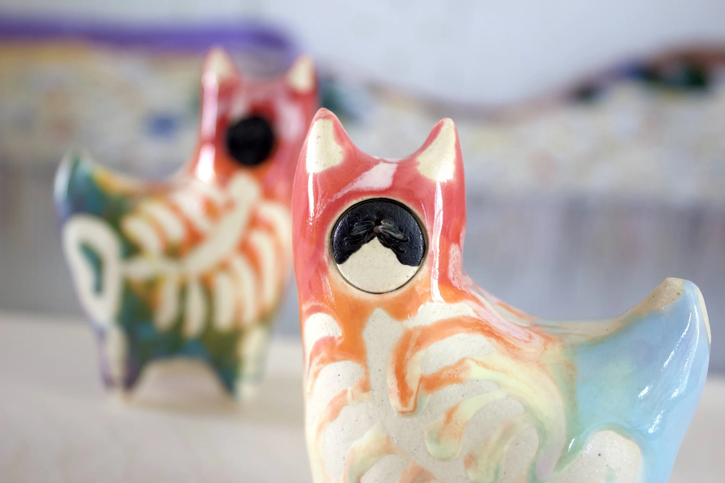 Detail view of the handmade large ceramic Pastel Rainbow Goo Skeleton Cat sculpture.jpegjpeg