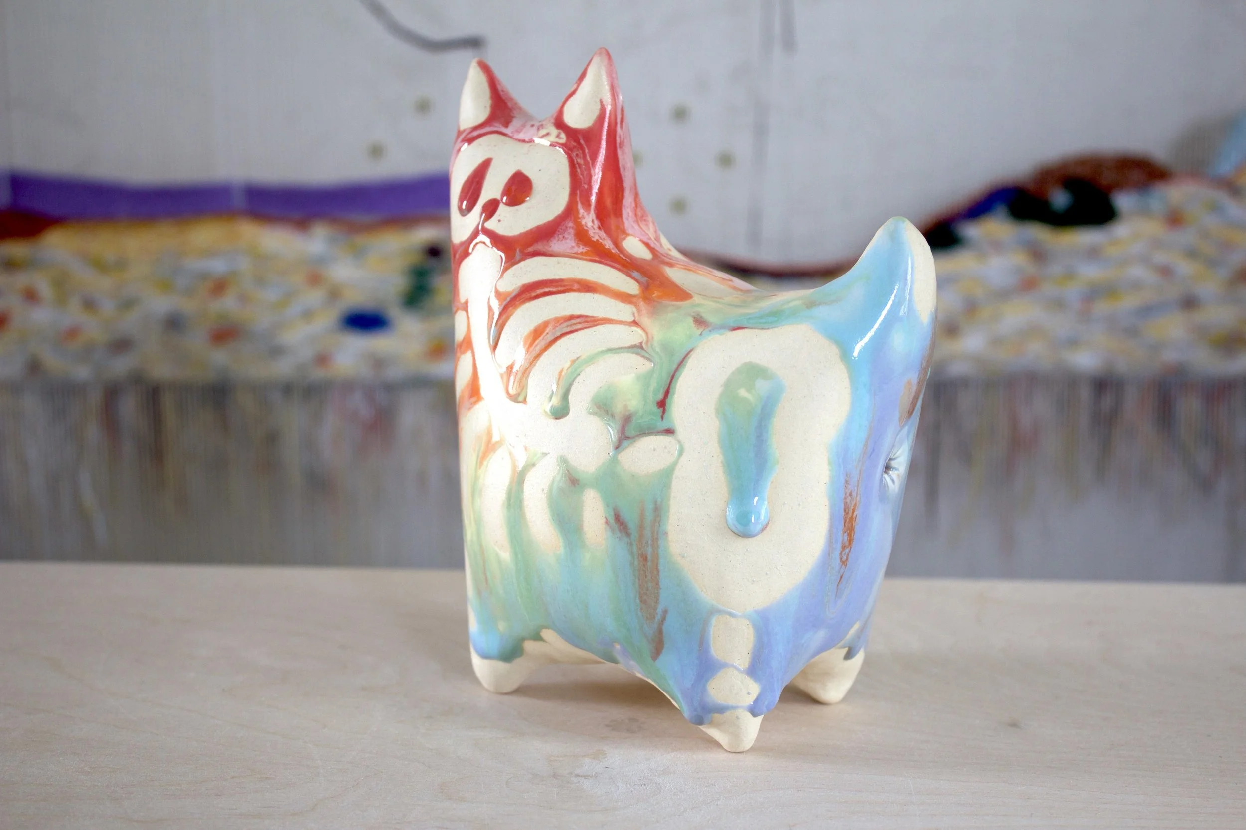 Three-quarter view of the XL Collector Pastel Goo Skeleton White Cat, a handmade ceramic cat sculpture.jpeg