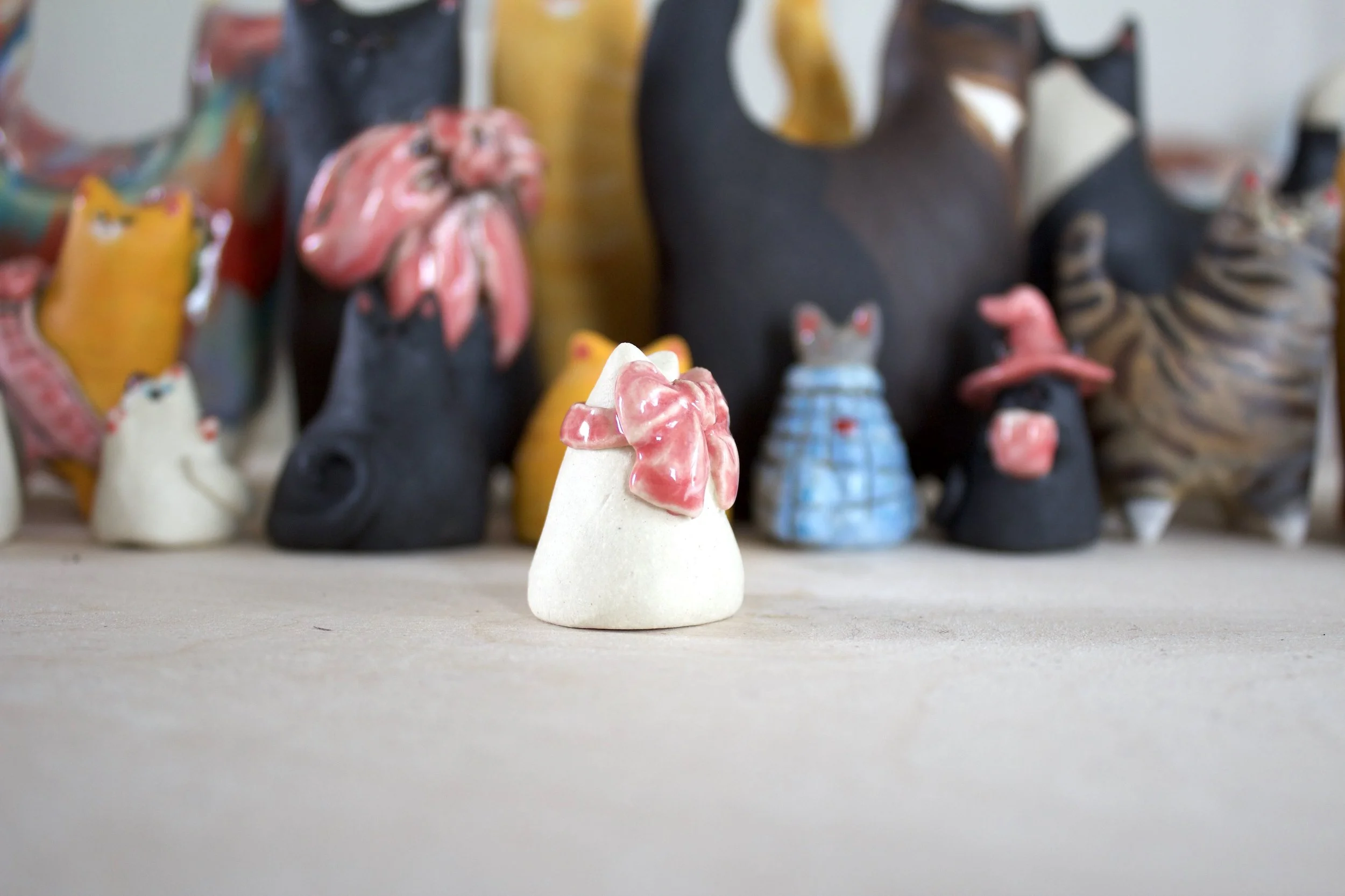 Side view Snowball ceramic cat chime handmade sculpture.jpeg