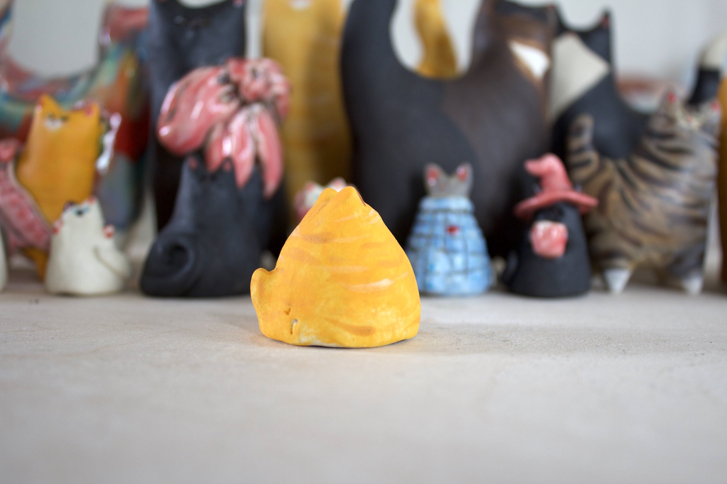 Side view of orange tabby ceramic cat chime handmade sculpture.jpeg