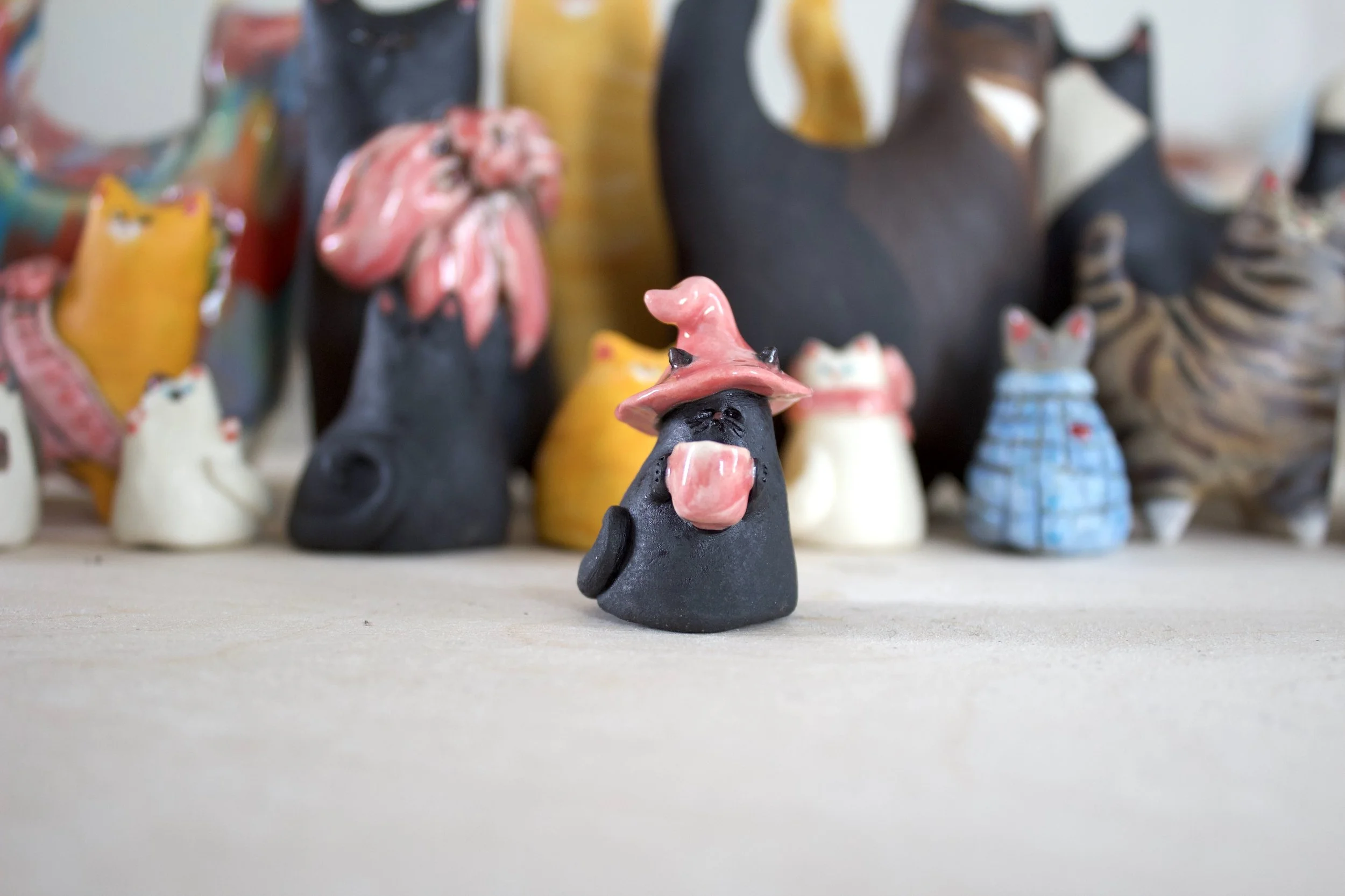 Void witch handmade ceramic cat chime with pink witch hat and pink coffee mug.jpeg