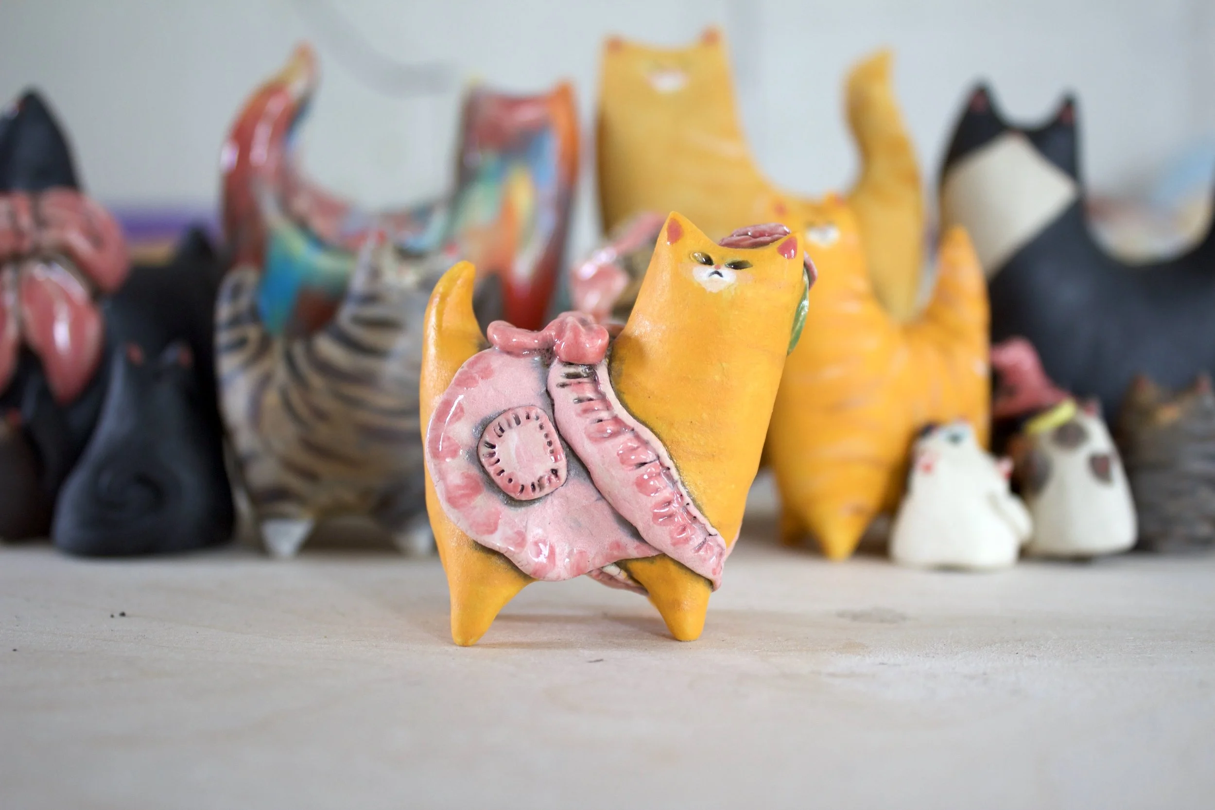 Ginger Tabby handmade ceramic cat sculpture with pink summer dress and rose.jpeg