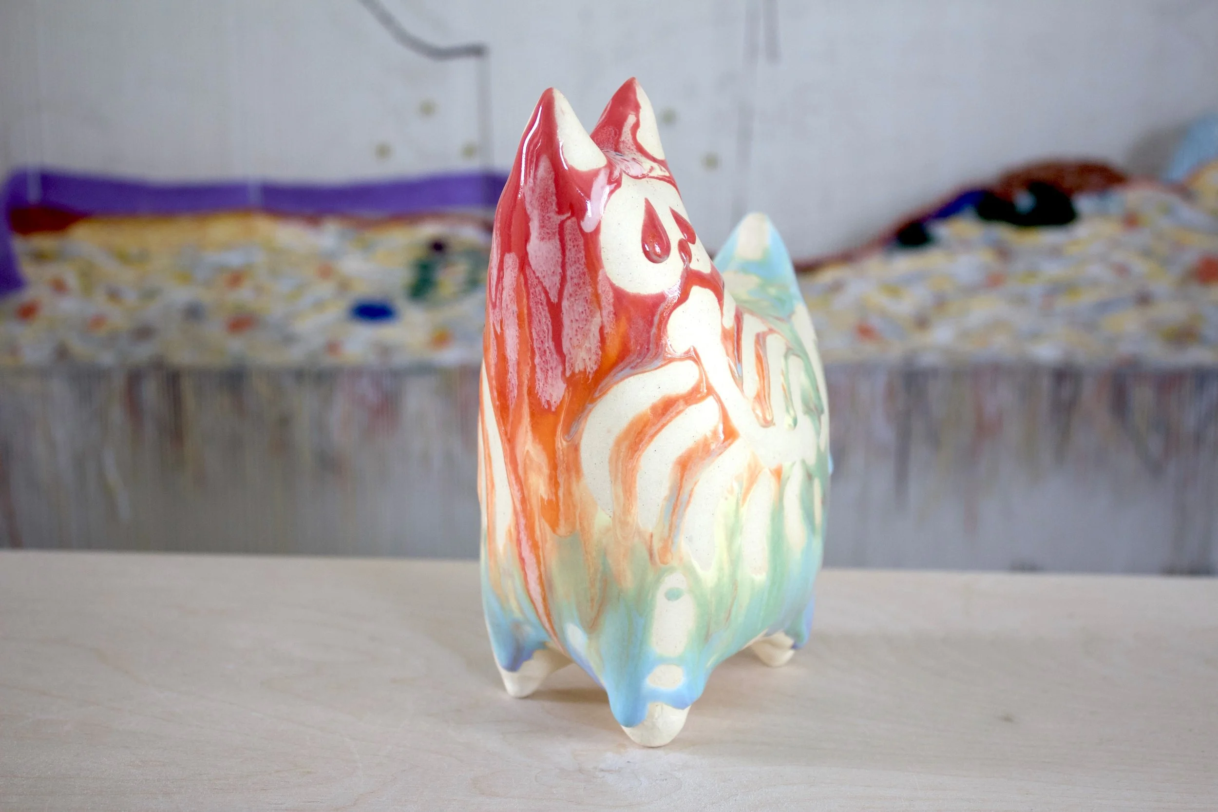 Three-quarter view of the XL Collector Pastel Goo Skeleton White Cat, a handmade ceramic cat sculpture.jpeg