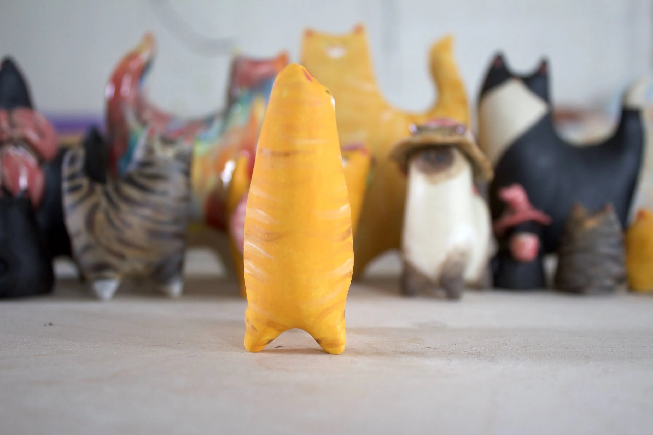 Side view orange tabby ceramic cat sculpture.jpeg
