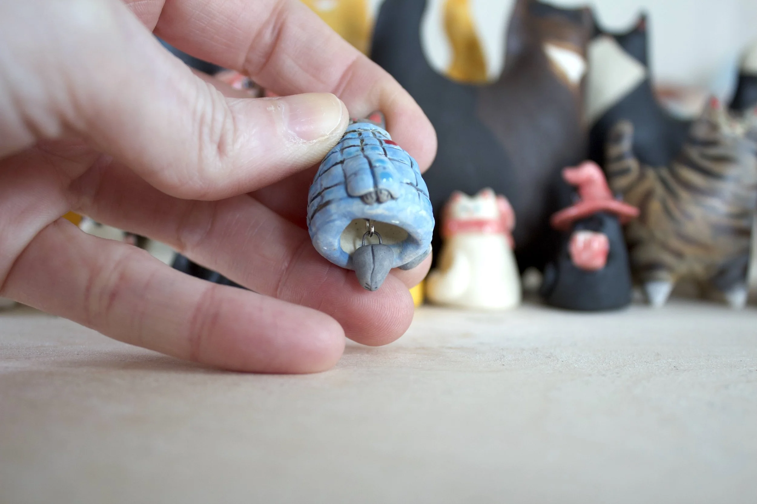 Sphynx ceramic cat chime paw clapper detail.jpeg