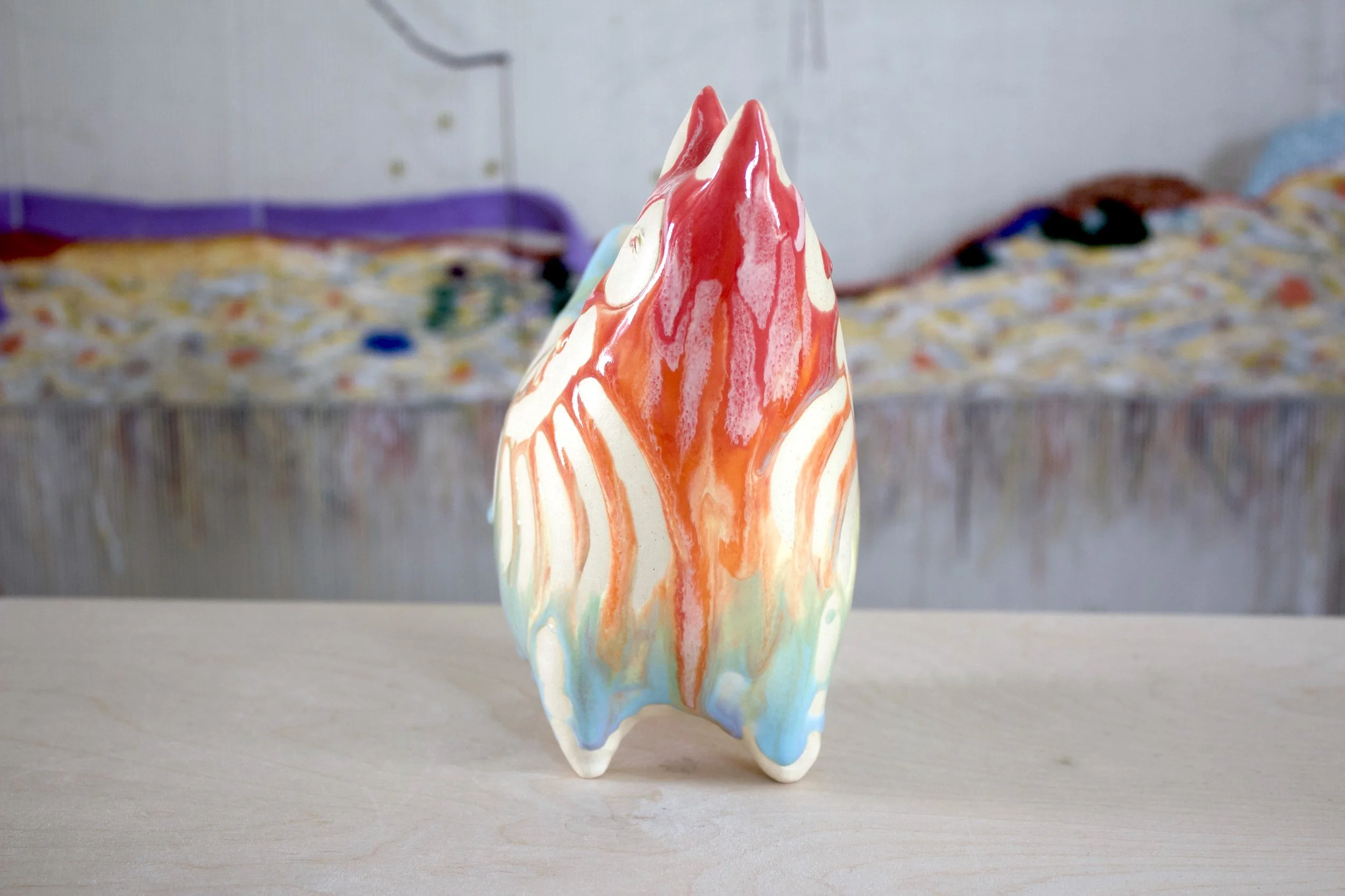 Side view of the handmade XL ceramic Pastel Goo Skeleton White Cat sculpture.jpeg