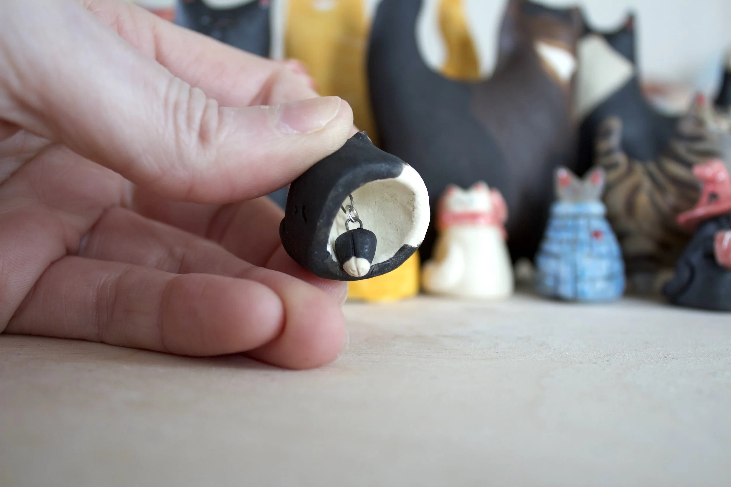 Tuxedo ceramic cat chime paw clapper.jpeg