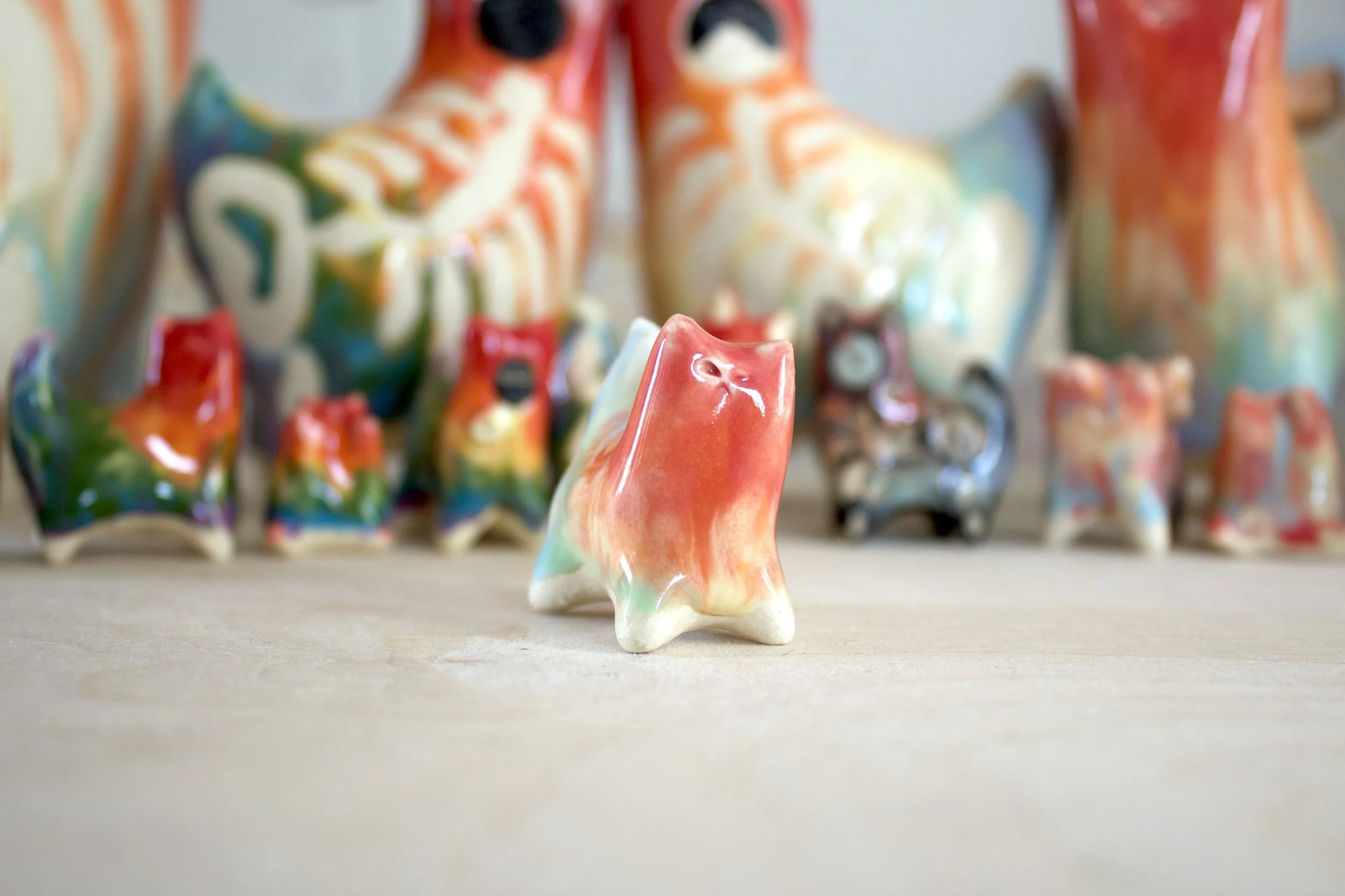 Three-quarter view of Pastel Rainbow Cat No. 2, a handmade ceramic cat sculpture.jpeg