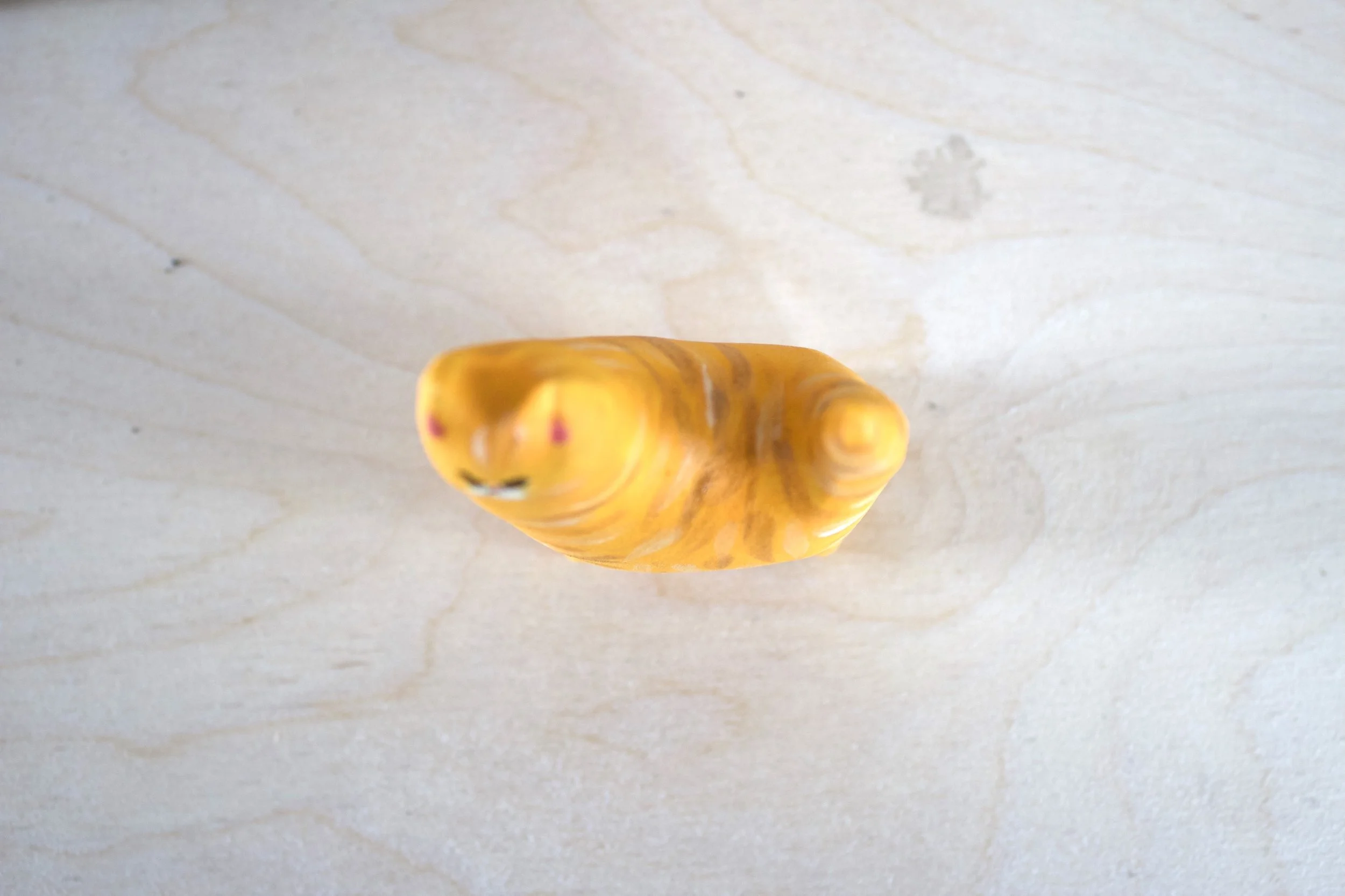Top view orange tabby ceramic cat sculpture.jpeg
