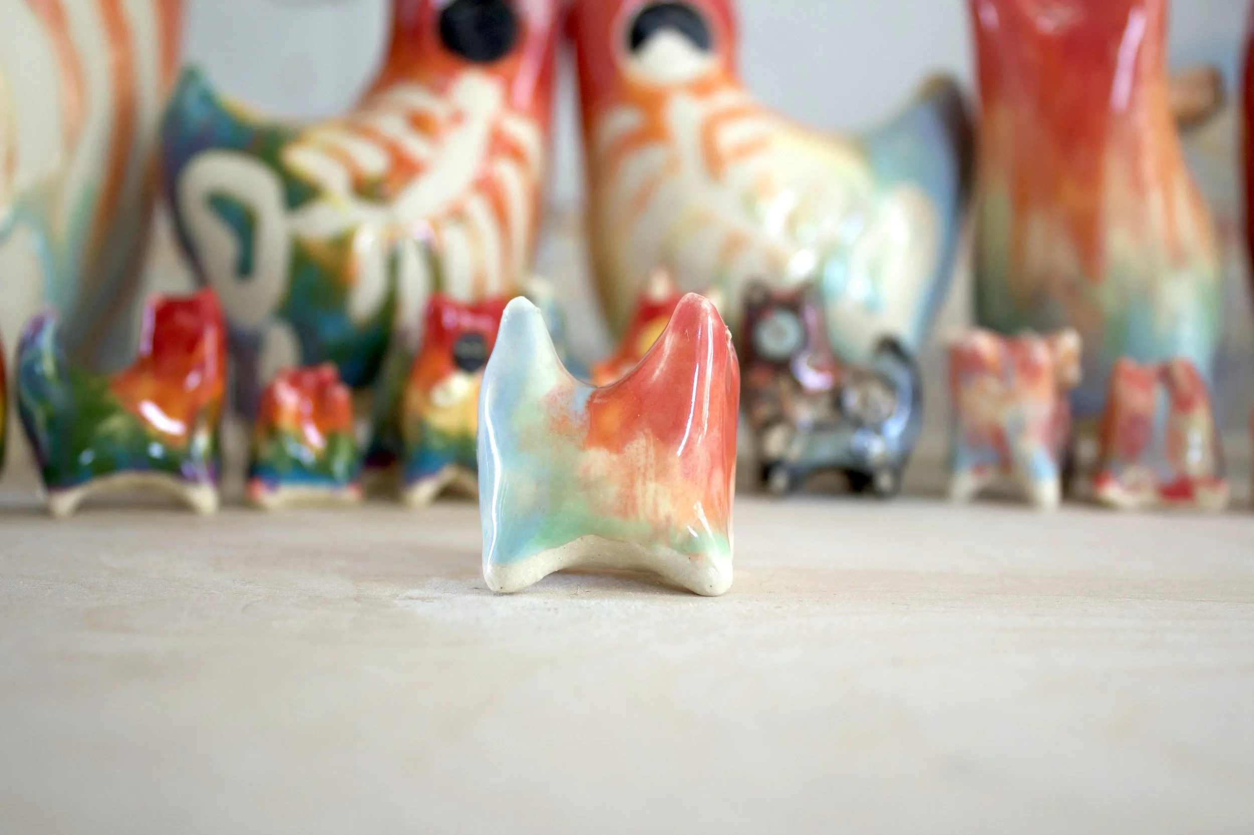Side view of Pastel Rainbow Cat No. 2 handmade ceramic cat sculpture.jpeg