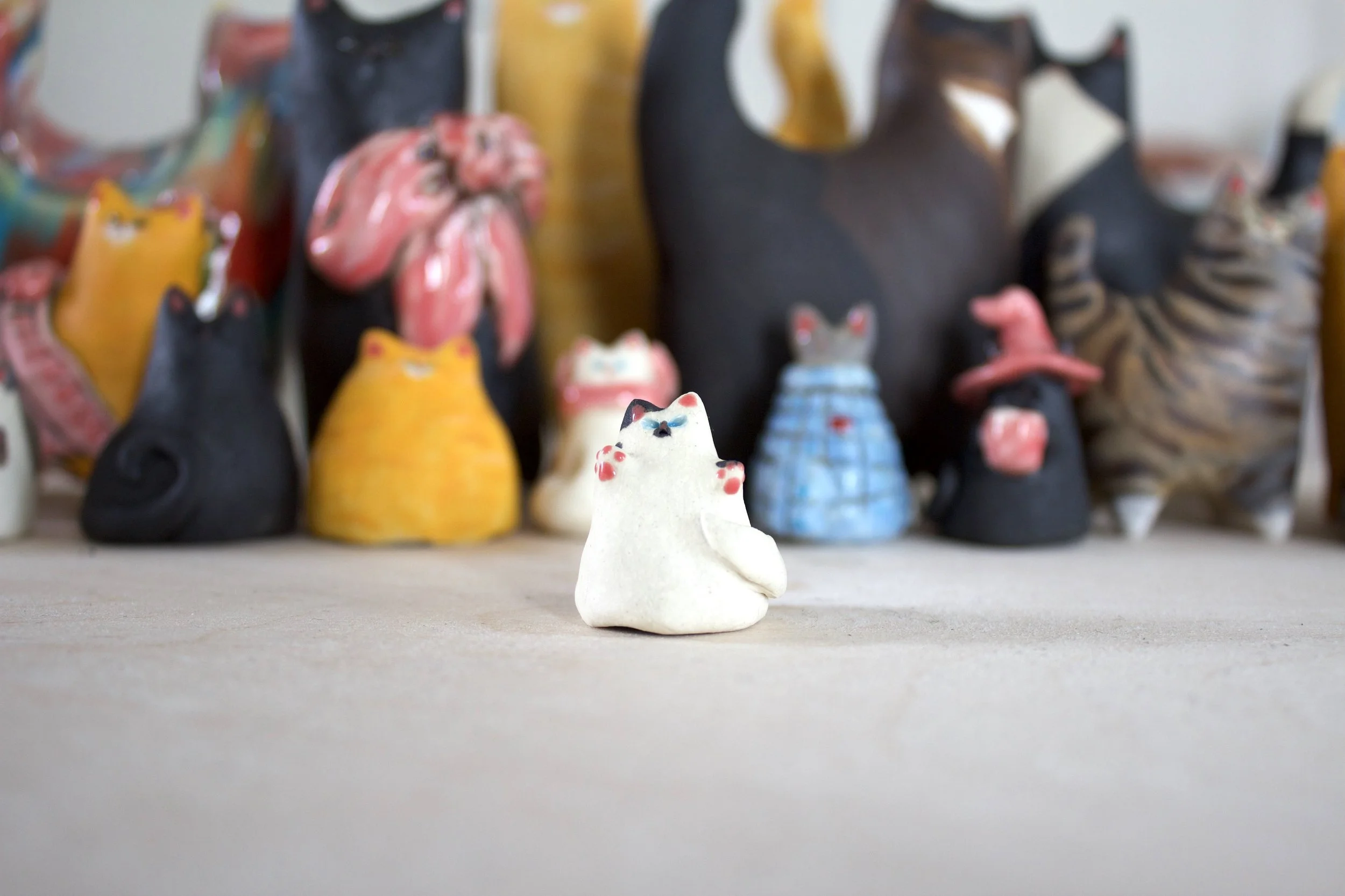 Piebald handmade ceramic cat chime sculpture with tiny toe beans.jpeg