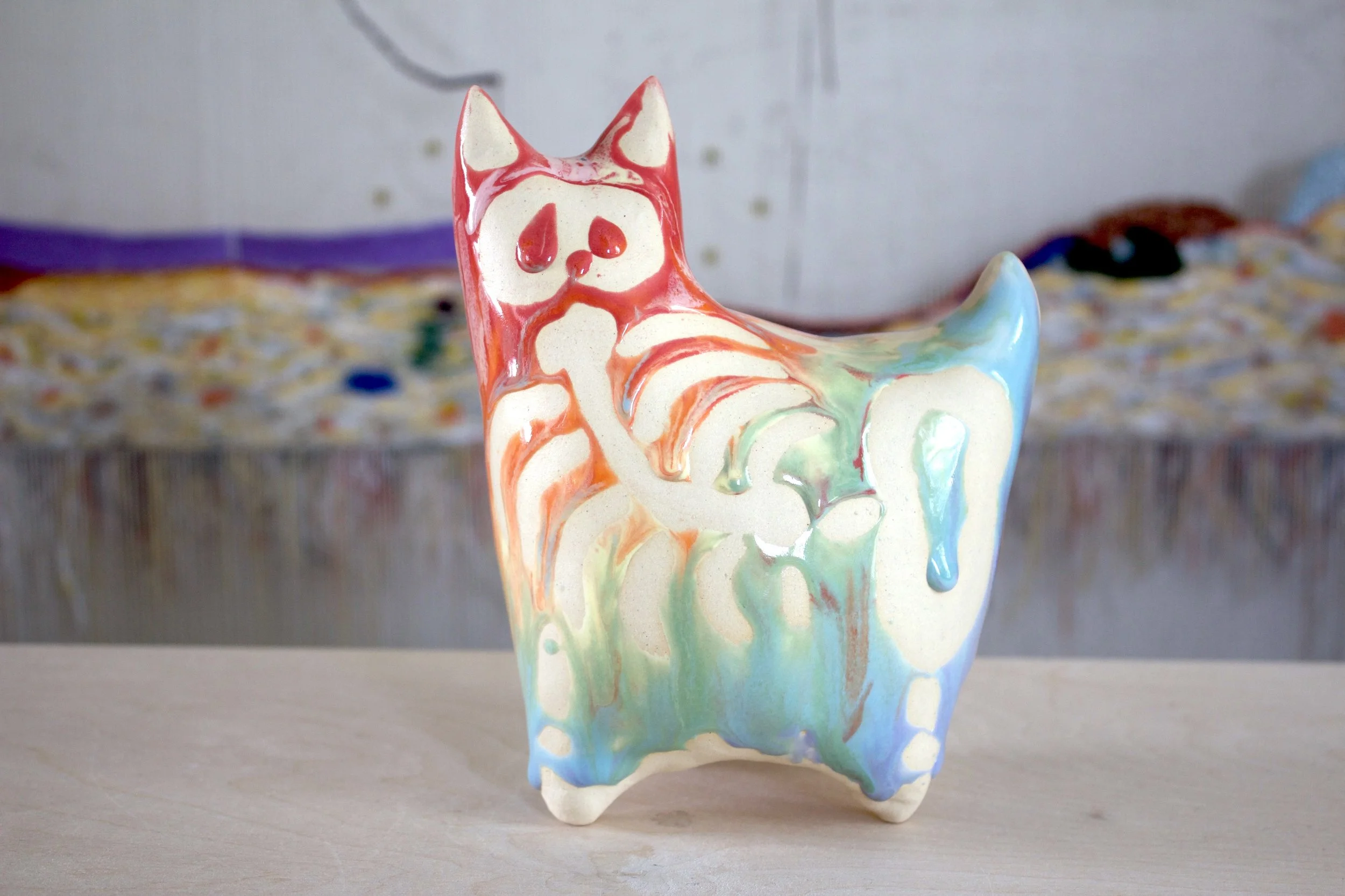 Side view of the handmade XL ceramic Pastel Goo Skeleton White Cat sculpture.jpeg