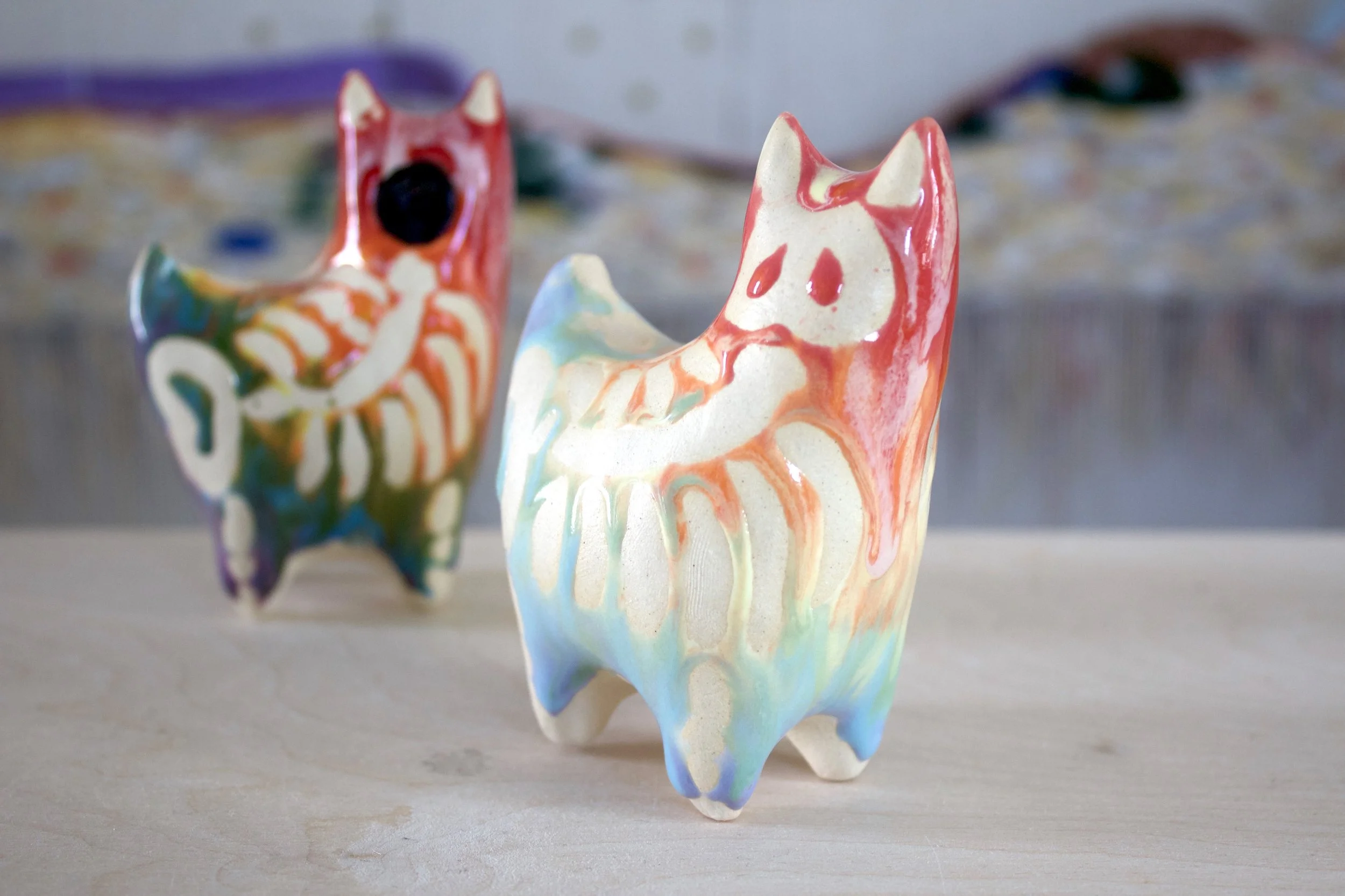 One-of-a-kind handmade large ceramic Pastel Rainbow Goo Skeleton Cat viewed from the front.jpeg