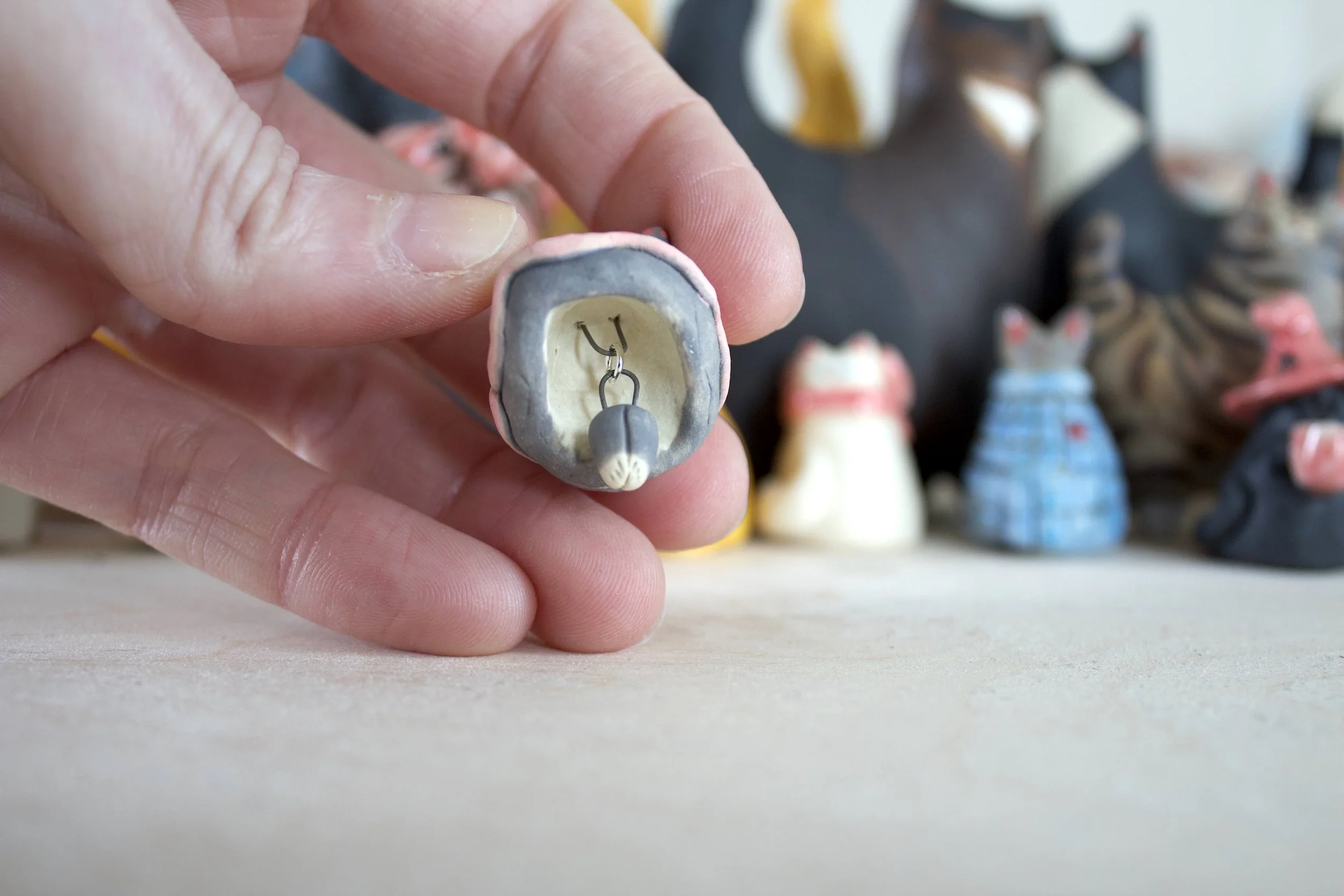 Gray ceramic cat chime paw clapper detail.jpeg
