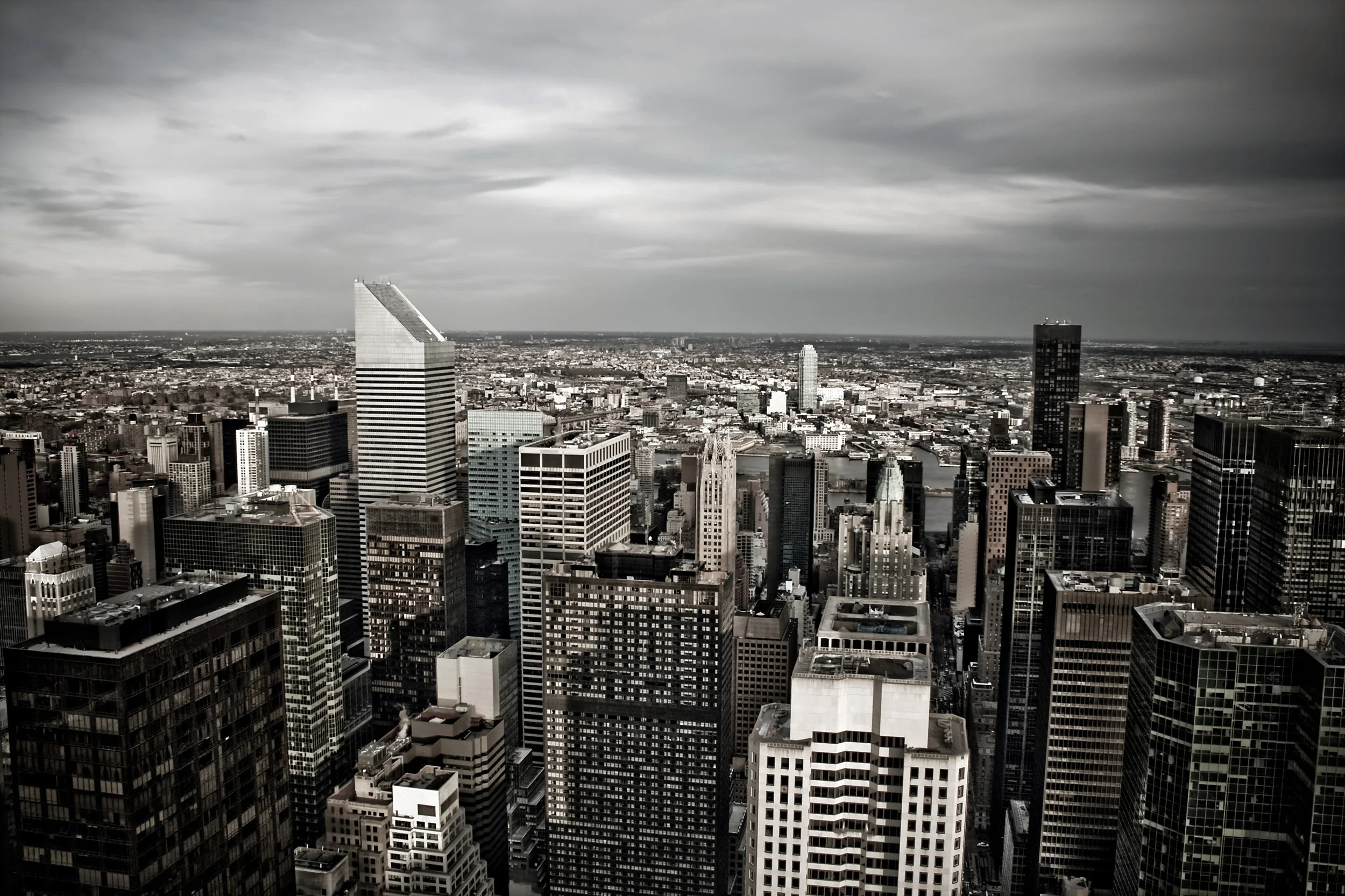 horizontal-aerial-view-of-the-manhattan-section-of-new-york-city-including-all-of-the-buildings-and-skyline-in-sepia-tone-with-vignetting_HKfxm4D0Ss.jpg