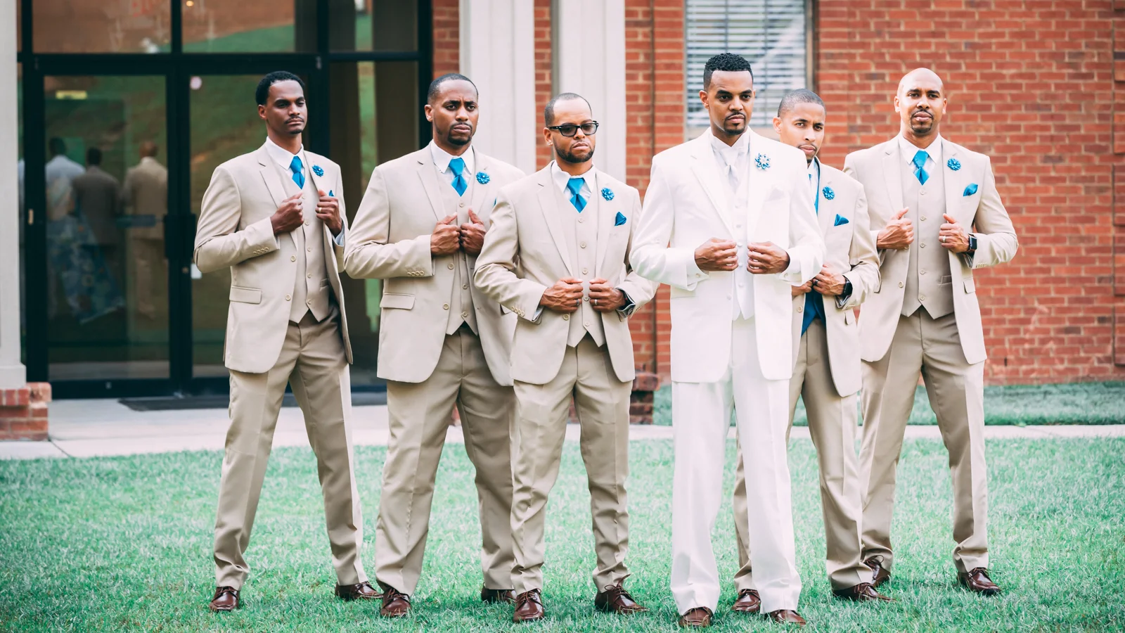 Black groom and groomsmen pose for the camera before wedding