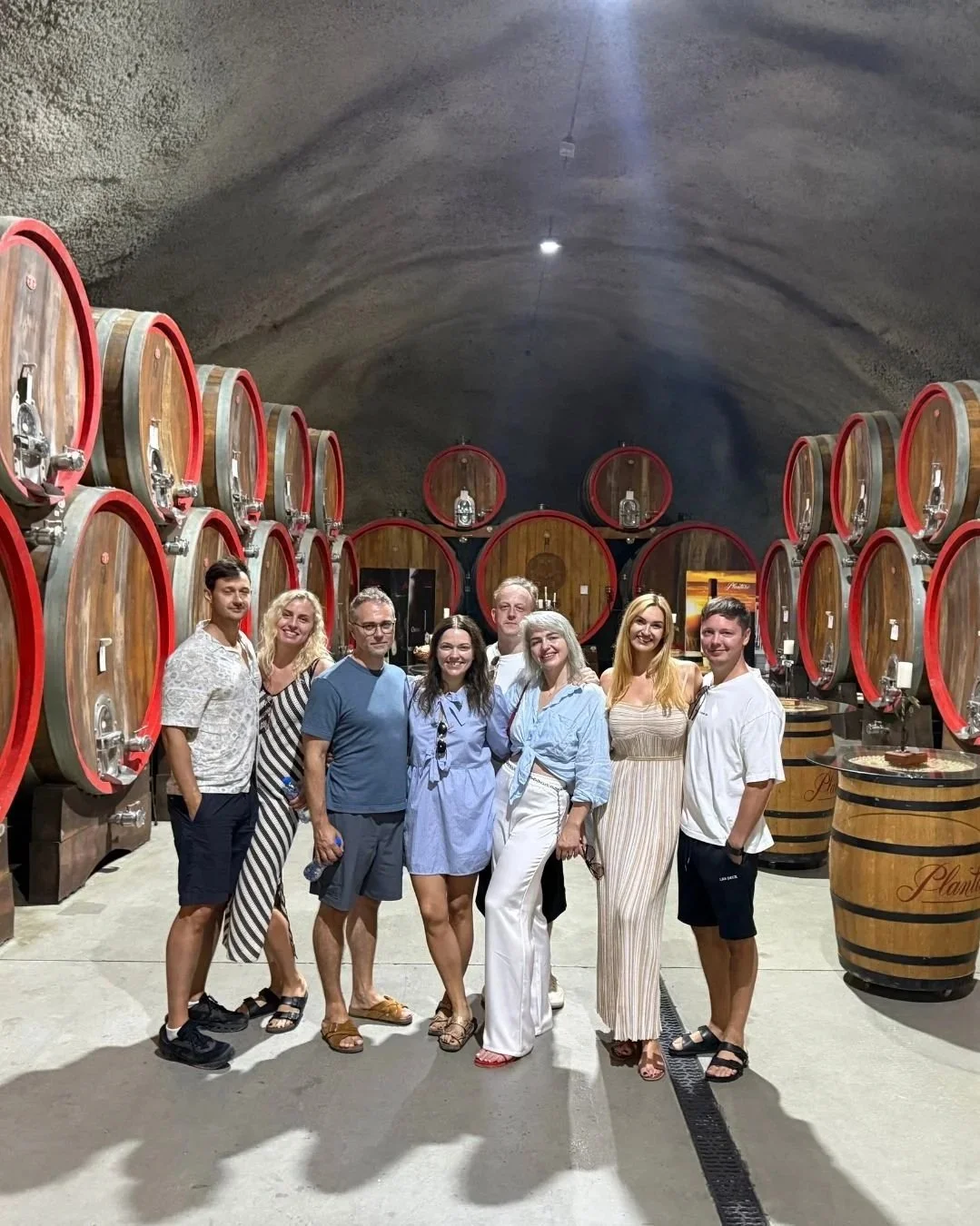 Guests tasting local wine in a Montenegrin wine cellar.