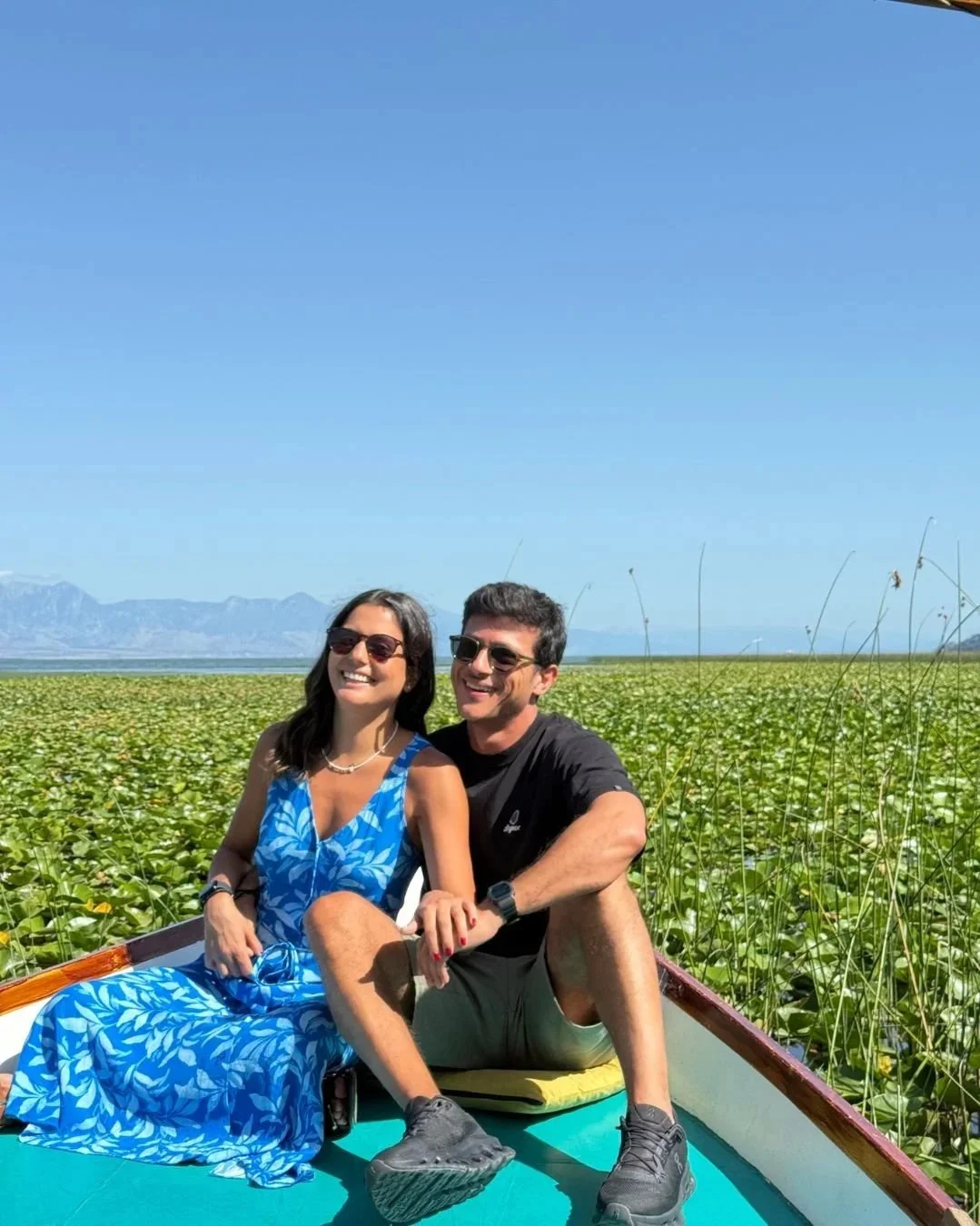 Couple on a boat sailing on Skadar Lake in Montenegro