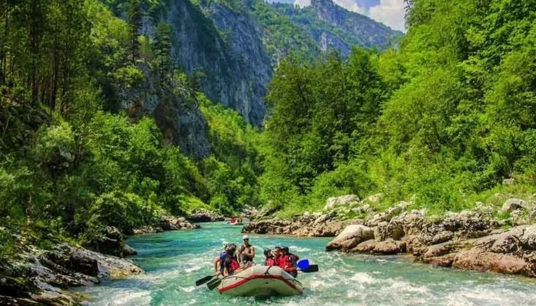 Visitors rafting through the clear waters and dramatic canyon of the Tara River in Montenegro.