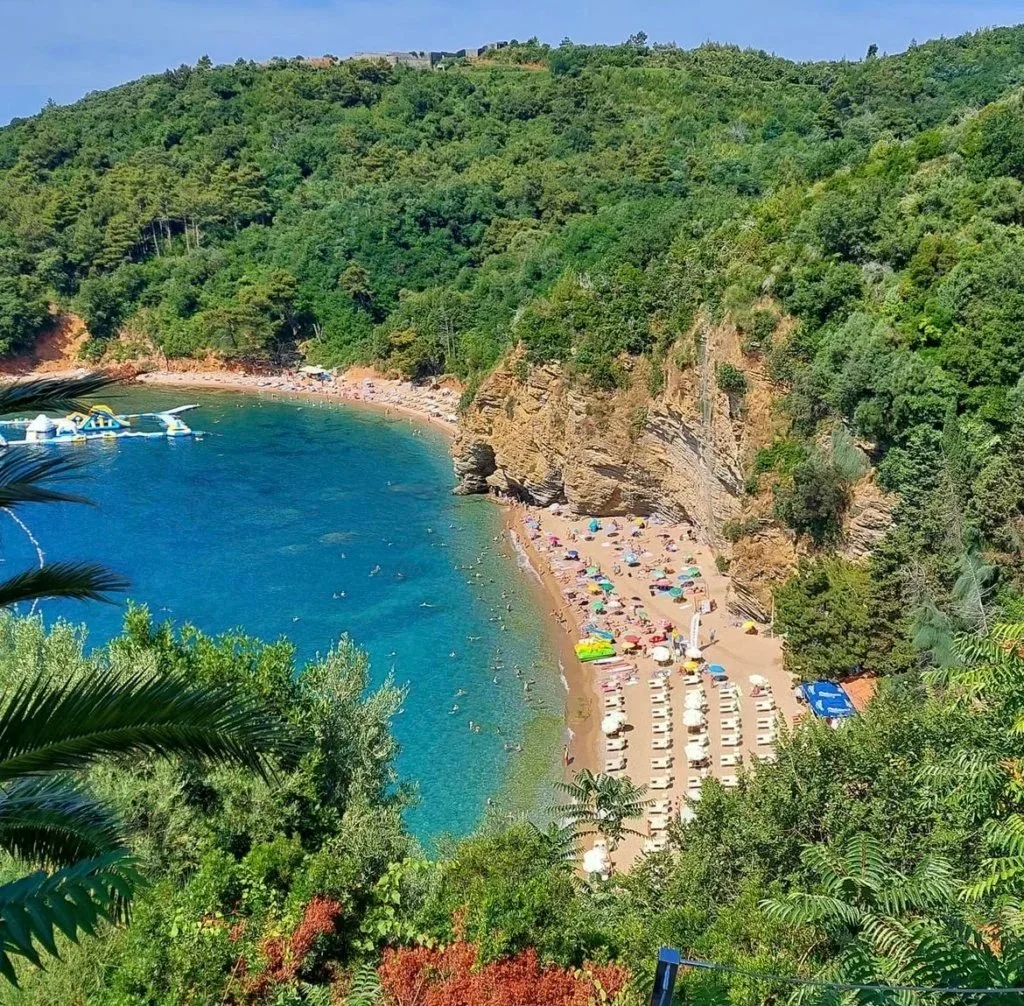 A sunny day at Mogren beach, with calm blue water