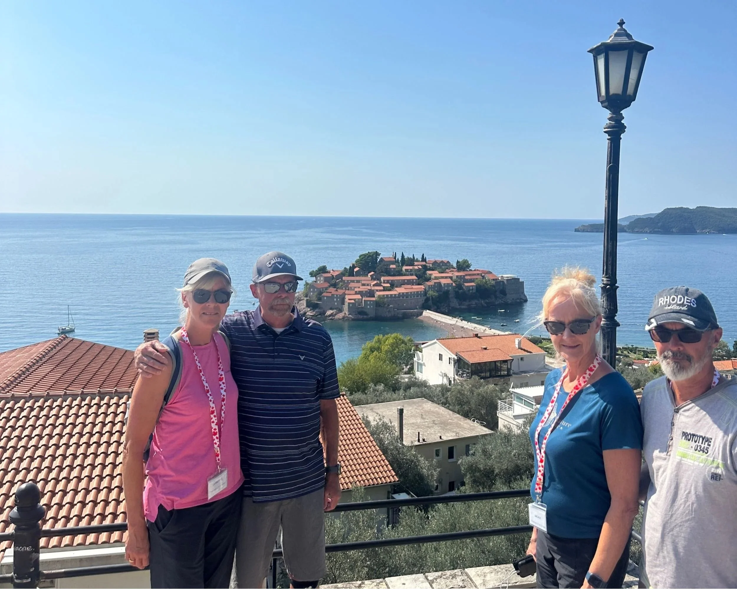 Guests posing with Sveti Stefan island in the background, Montenegro.