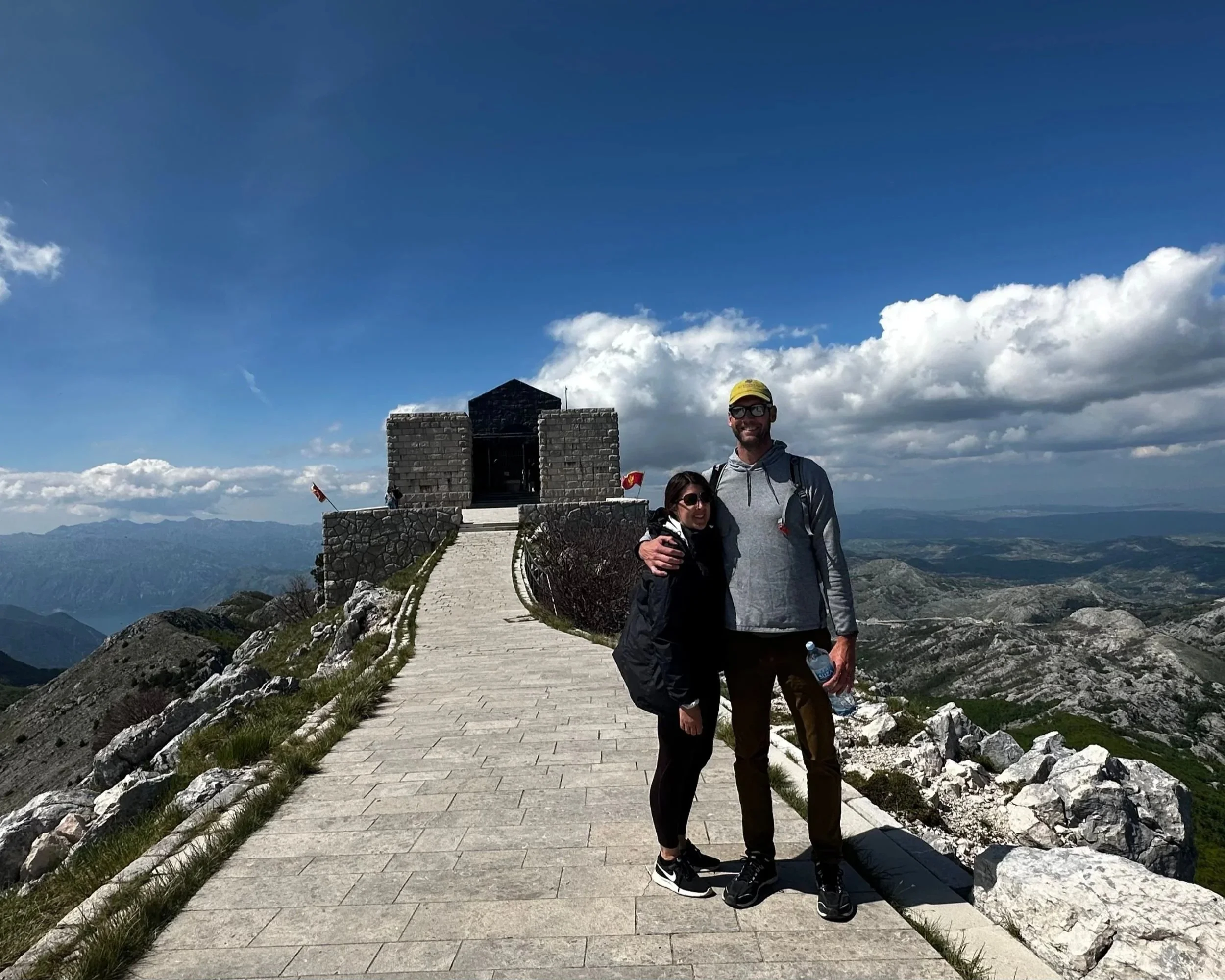 Guests standing in front of the Njegoš Mausoleum on Mount Lovćen, Montenegro.
