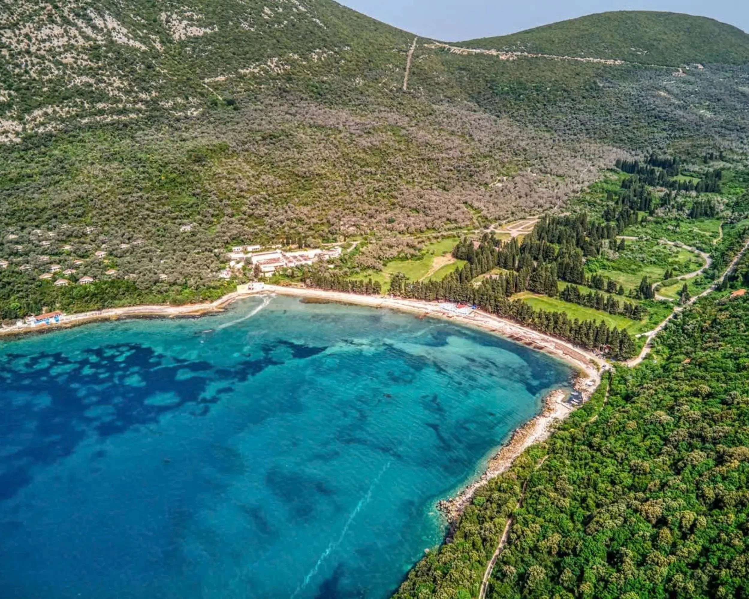 Valdanos beach with calm Mediterranean water and olive trees