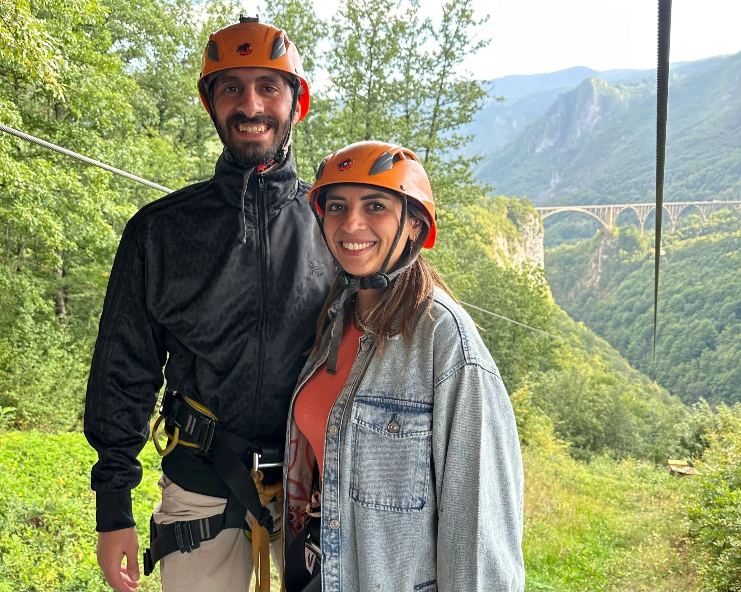 Guests riding a zipline through the mountains of Montenegro.