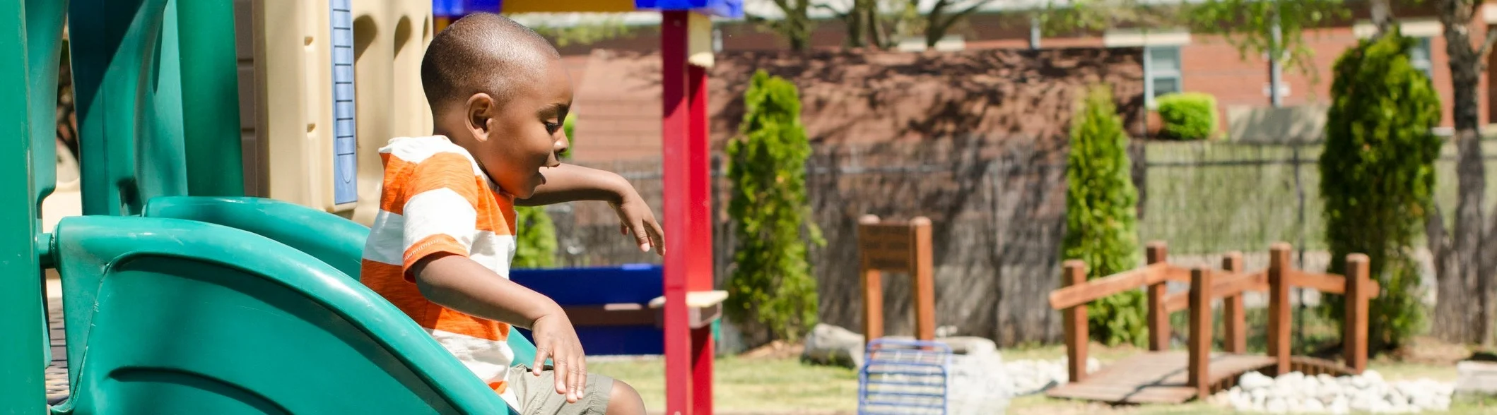 Preschool+African+American+Boy+Going+Down+Slide.jpg
