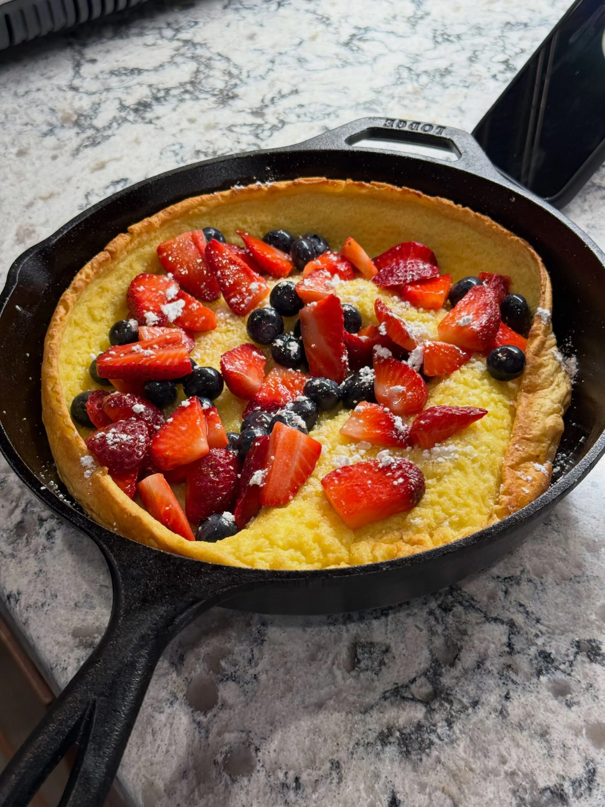 This might be the easiest way to make brunch look impressive. 🍓

A cast iron Dutch baby puffs up dramatically in the oven with crispy golden edges and a soft, custardy center. And unlike pancakes, there&rsquo;s no standing at the stove flipping batc