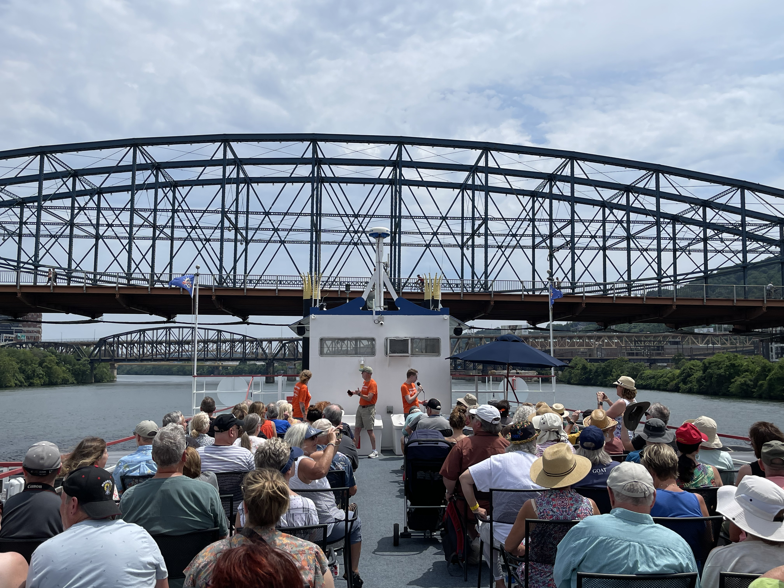  Guests listen to speakers on boat tour. 