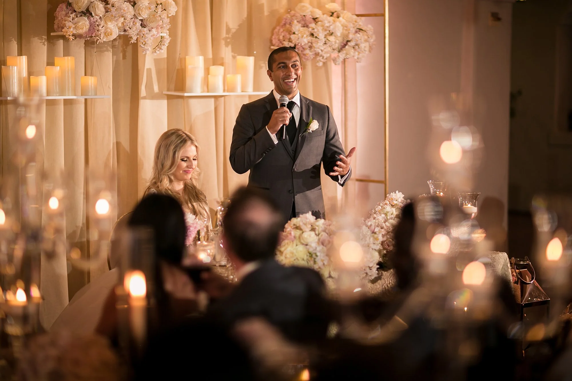 People celebrating at a wedding reception with smoke cannons and confetti, dancing and enjoying the moment.