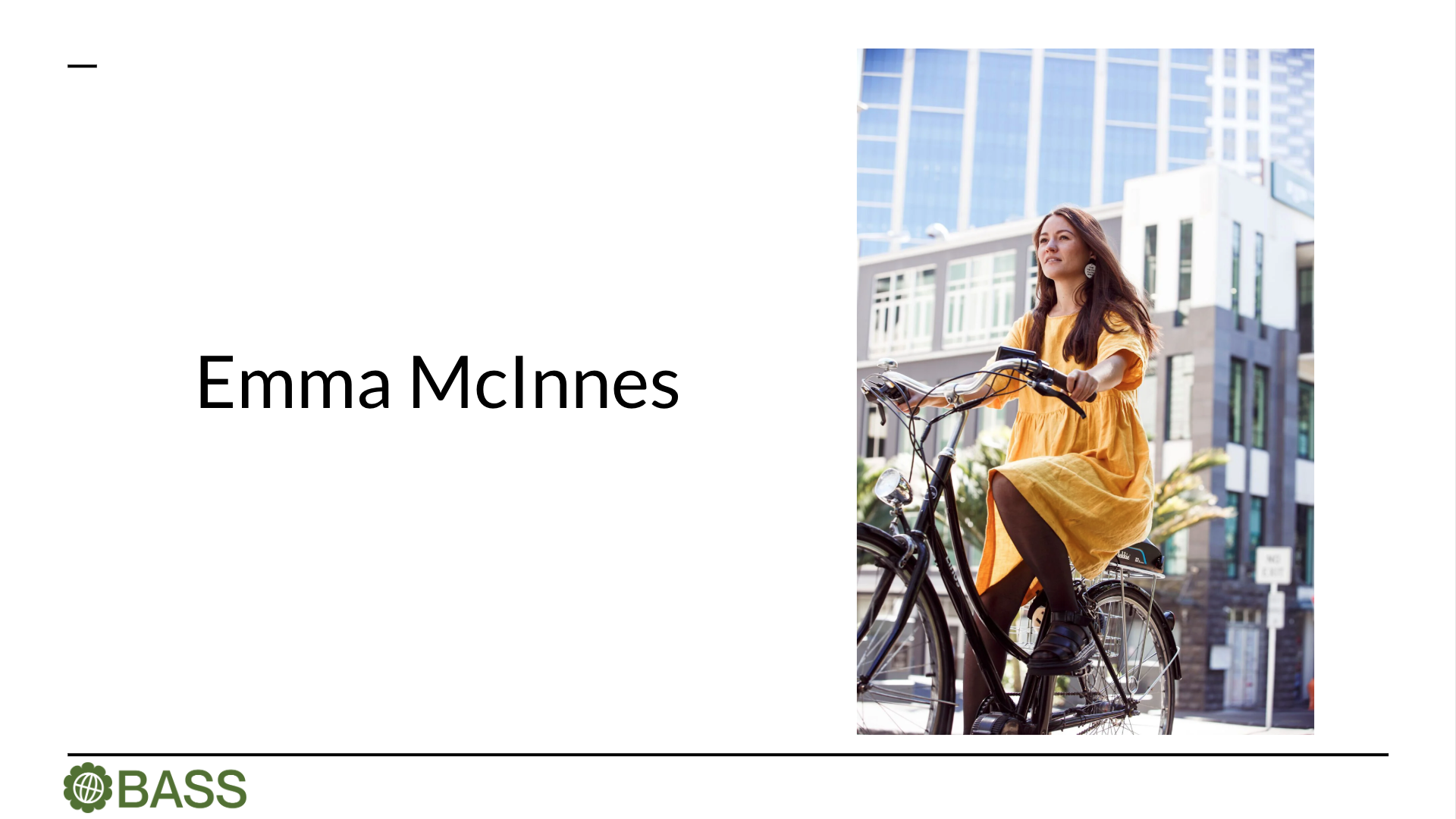 Emma rides her bicycle through the city in a yellow dress. The sun is shining and the scene feels hopeful.
