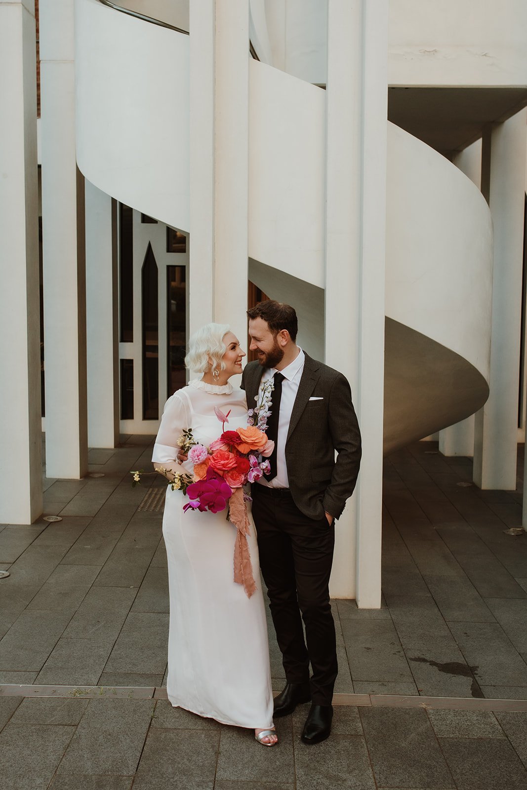 Amy and Mitch with a colourful wedding bouquet at COMO The Treasury in Perth
